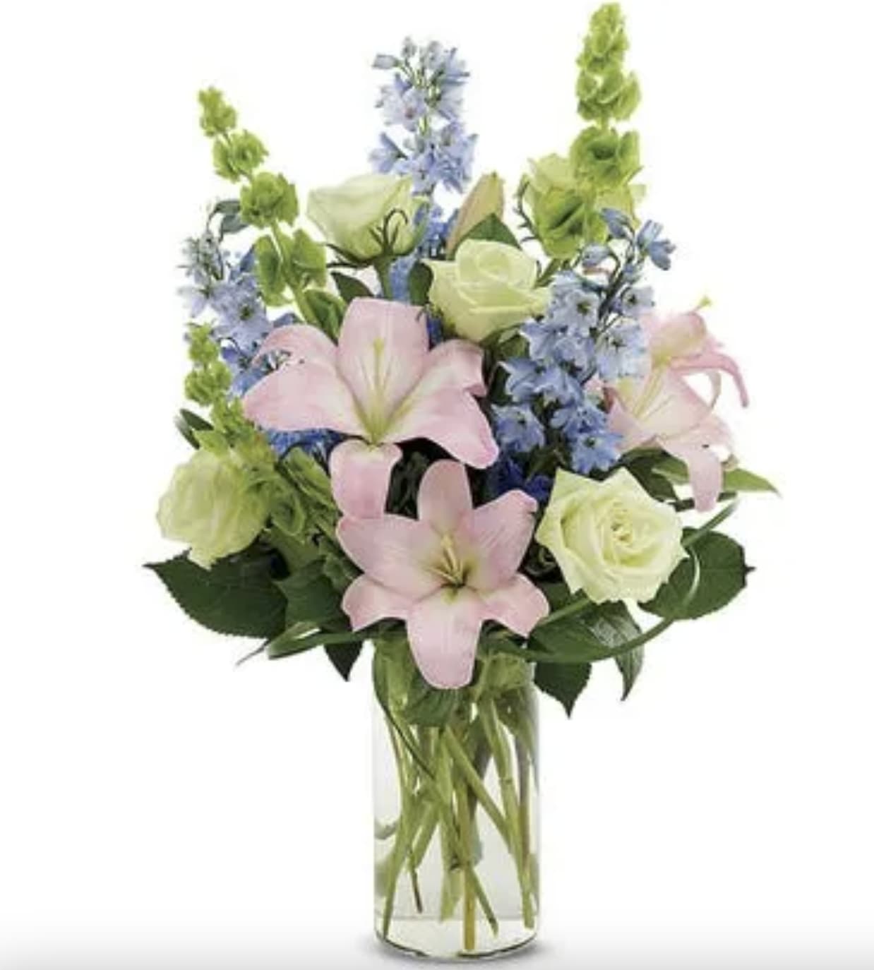 Bouquet of pink lilies, white roses, and blue flowers in a clear glass vase