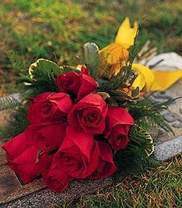 Bouquet of red roses with yellow flowers and greenery
