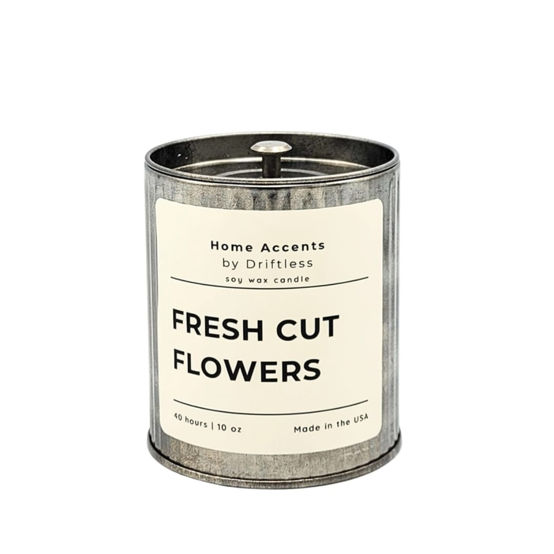 Soy wax candle in a metal tin labeled Fresh Cut Flowers