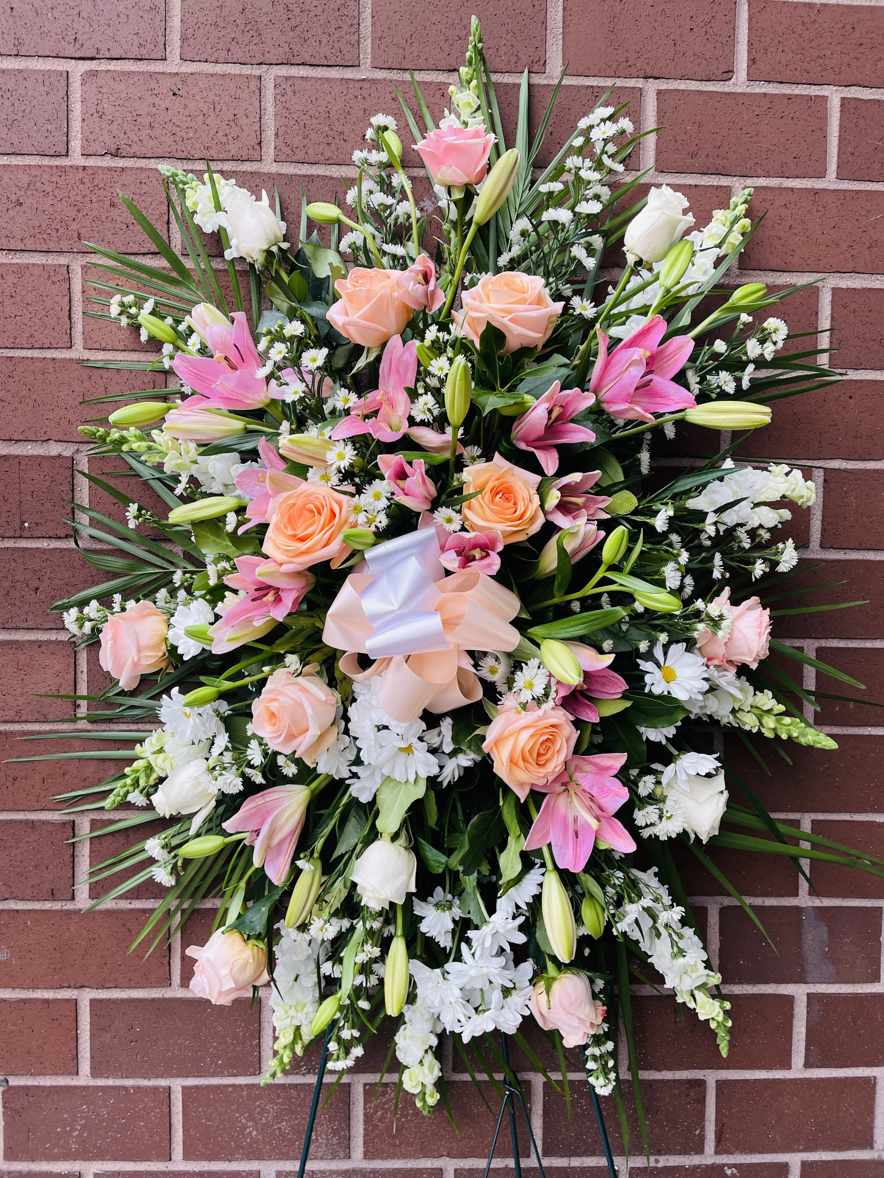 Large pink and white floral standing spray with roses and lilies