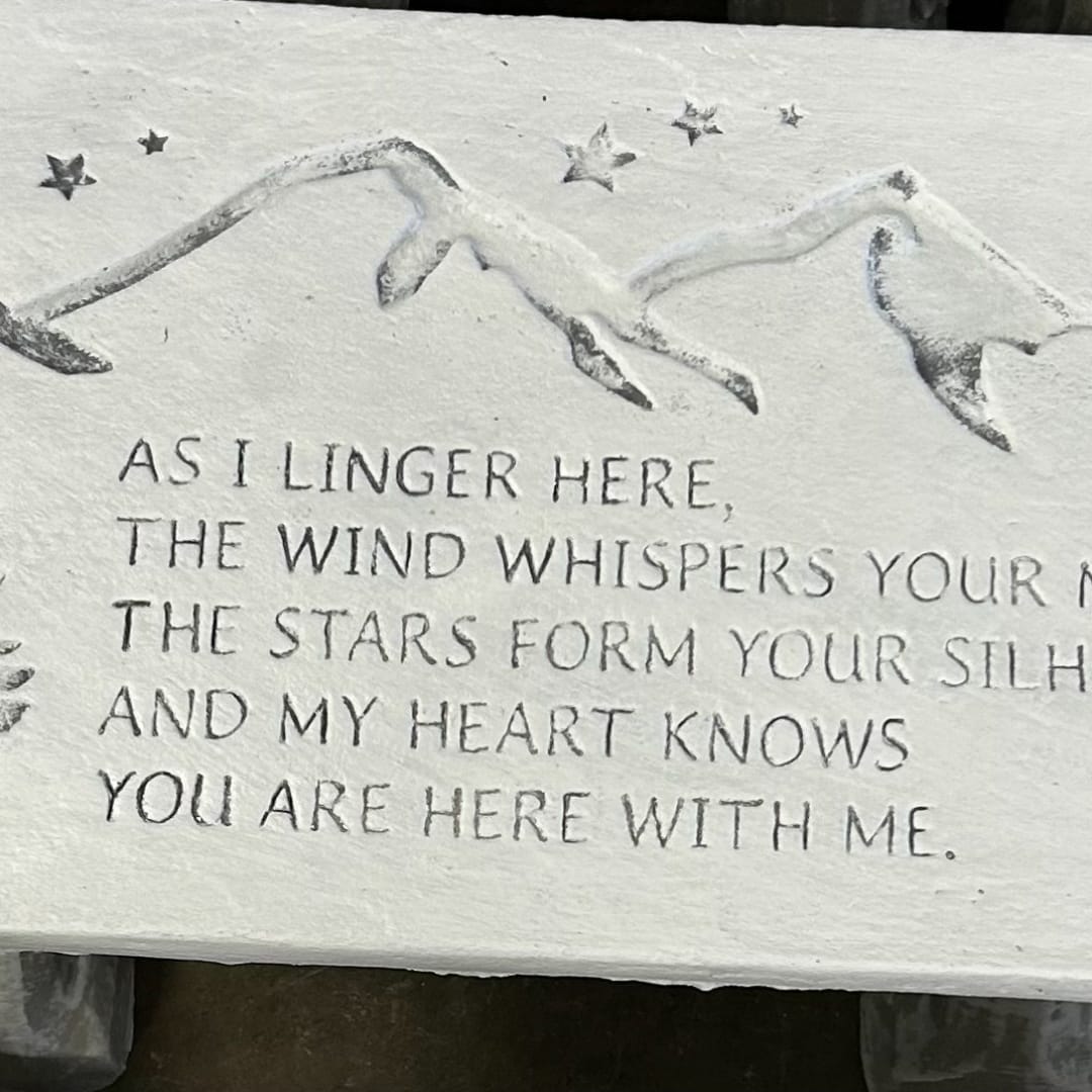 Stone plaque with a mountain relief and engraved memorial text