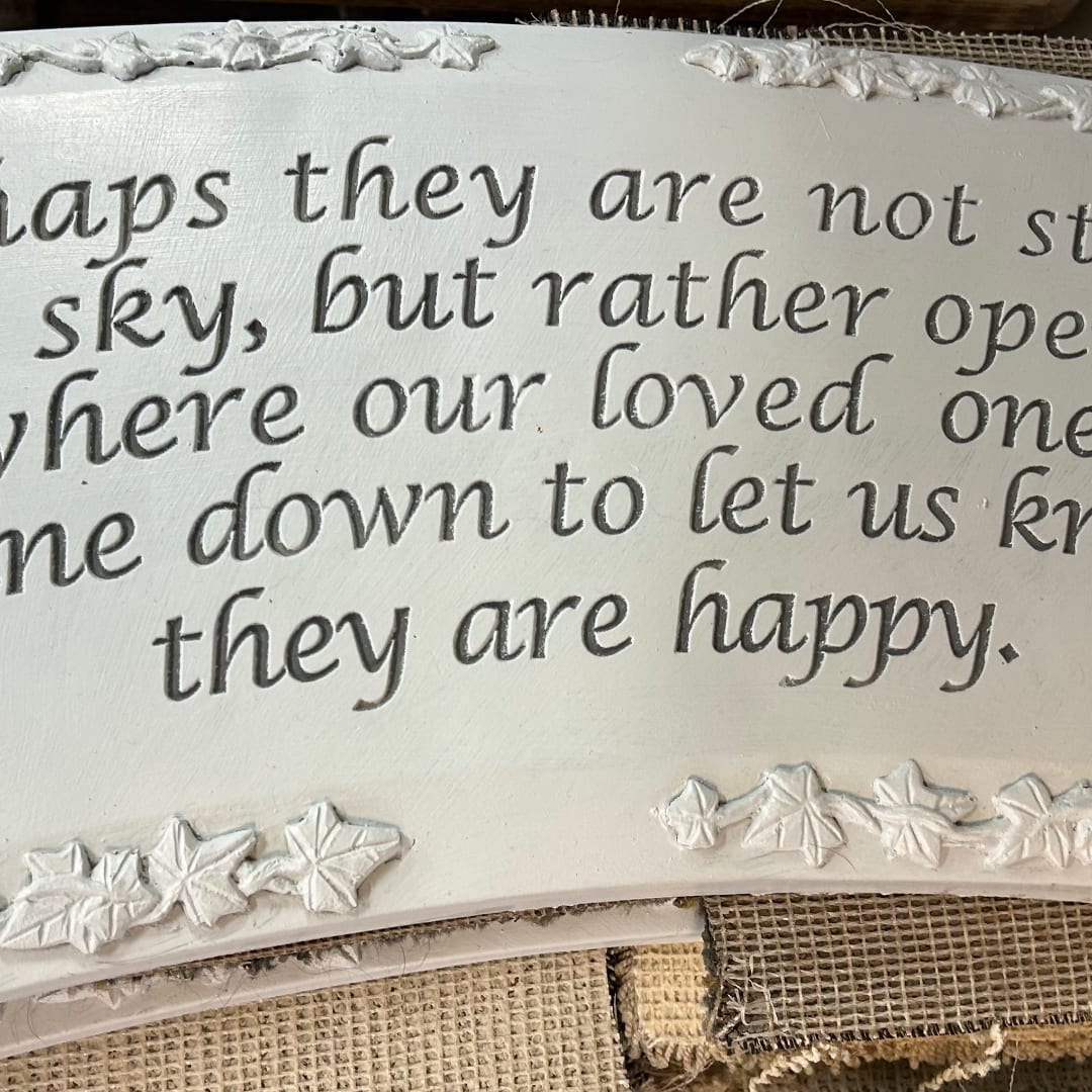Decorative sign with cursive text and raised leaf border