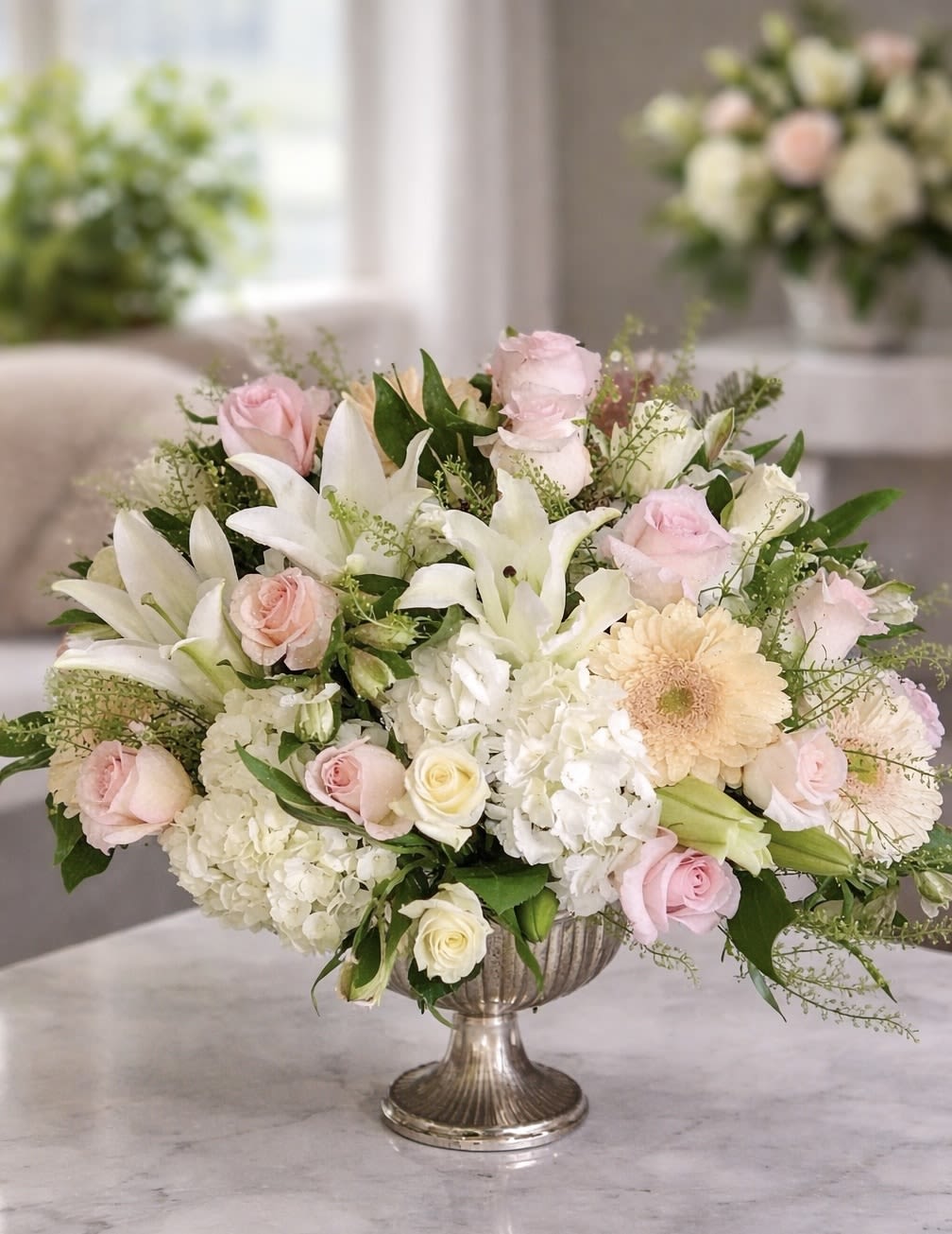 Soft Whisper - Soft Whisper is a delicate, garden-inspired arrangement in soft shades of blush, ivory, and fresh green. Featuring roses, hydrangea, lilies, and seasonal blooms, this design feels light, airy, and timeless. Gentle and romantic, it’s perfect for meaningful gifts, celebrations, or adding a touch of quiet elegance to any space.