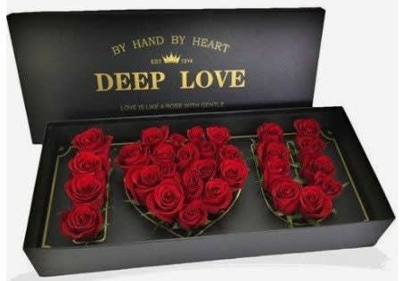 Red roses arranged in a black gift box spelling "DEEP LOVE"