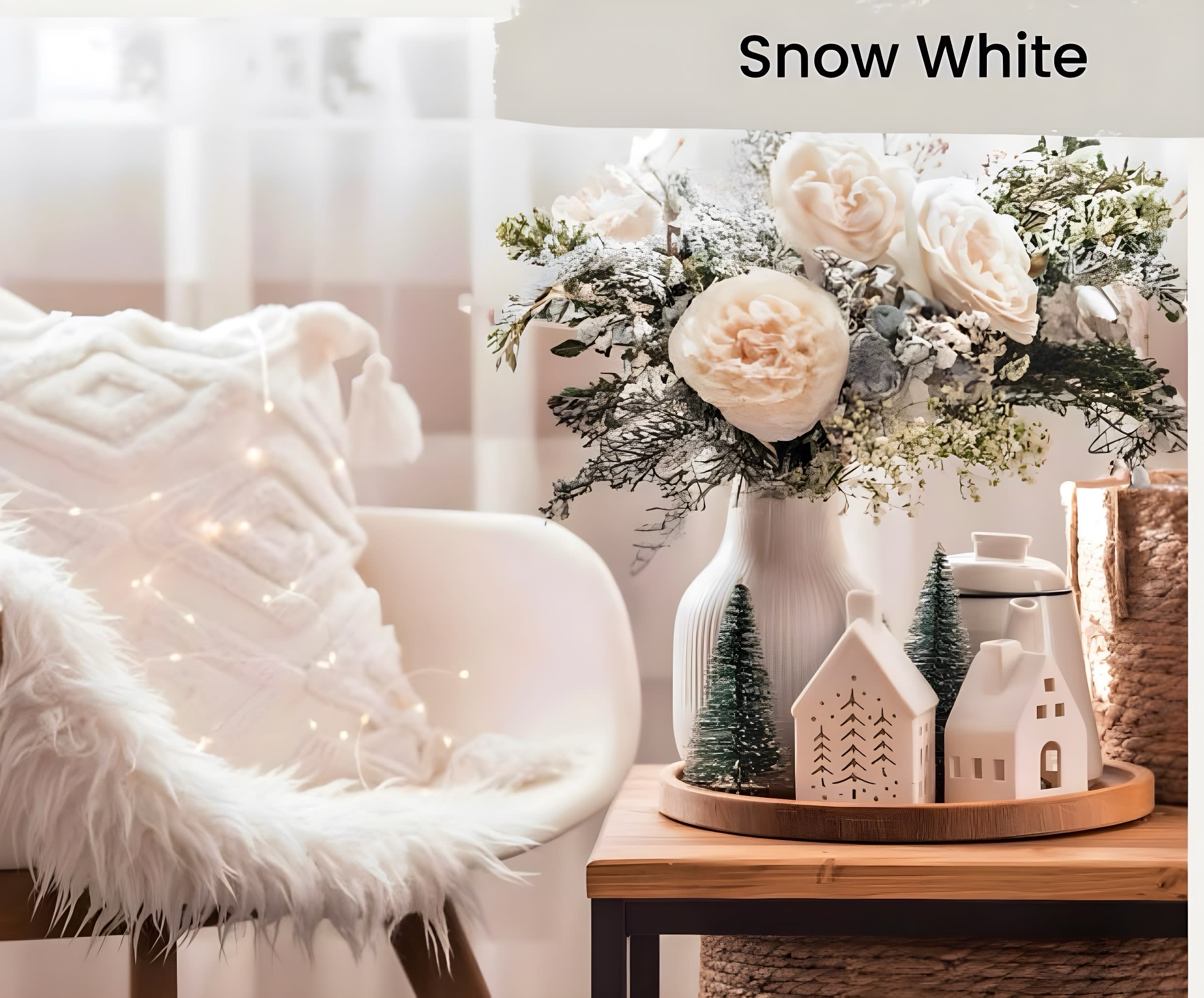 White rose arrangement in a ribbed vase with small decorative houses