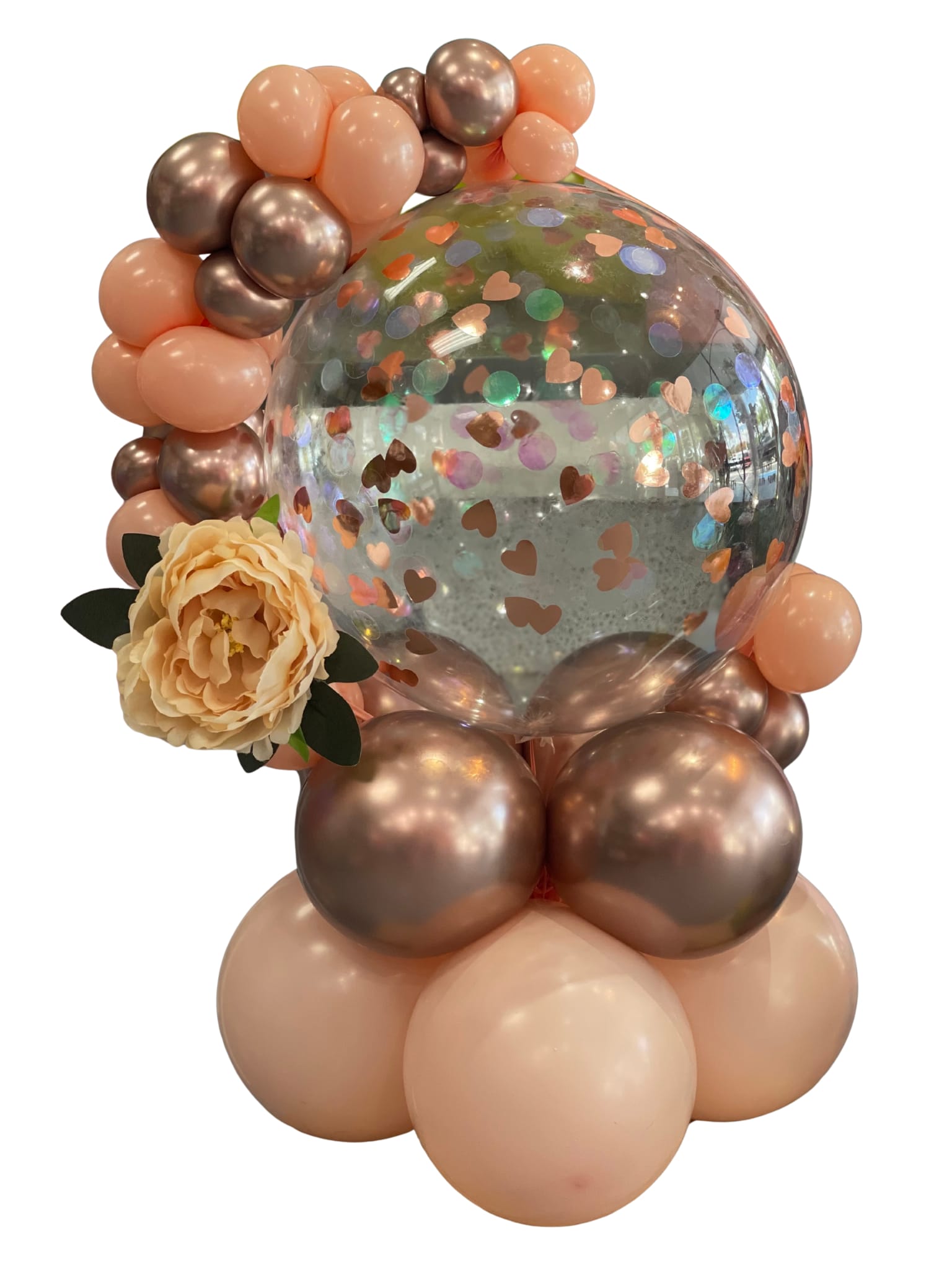 Balloon arrangement with a clear confetti balloon and a peach flower accent
