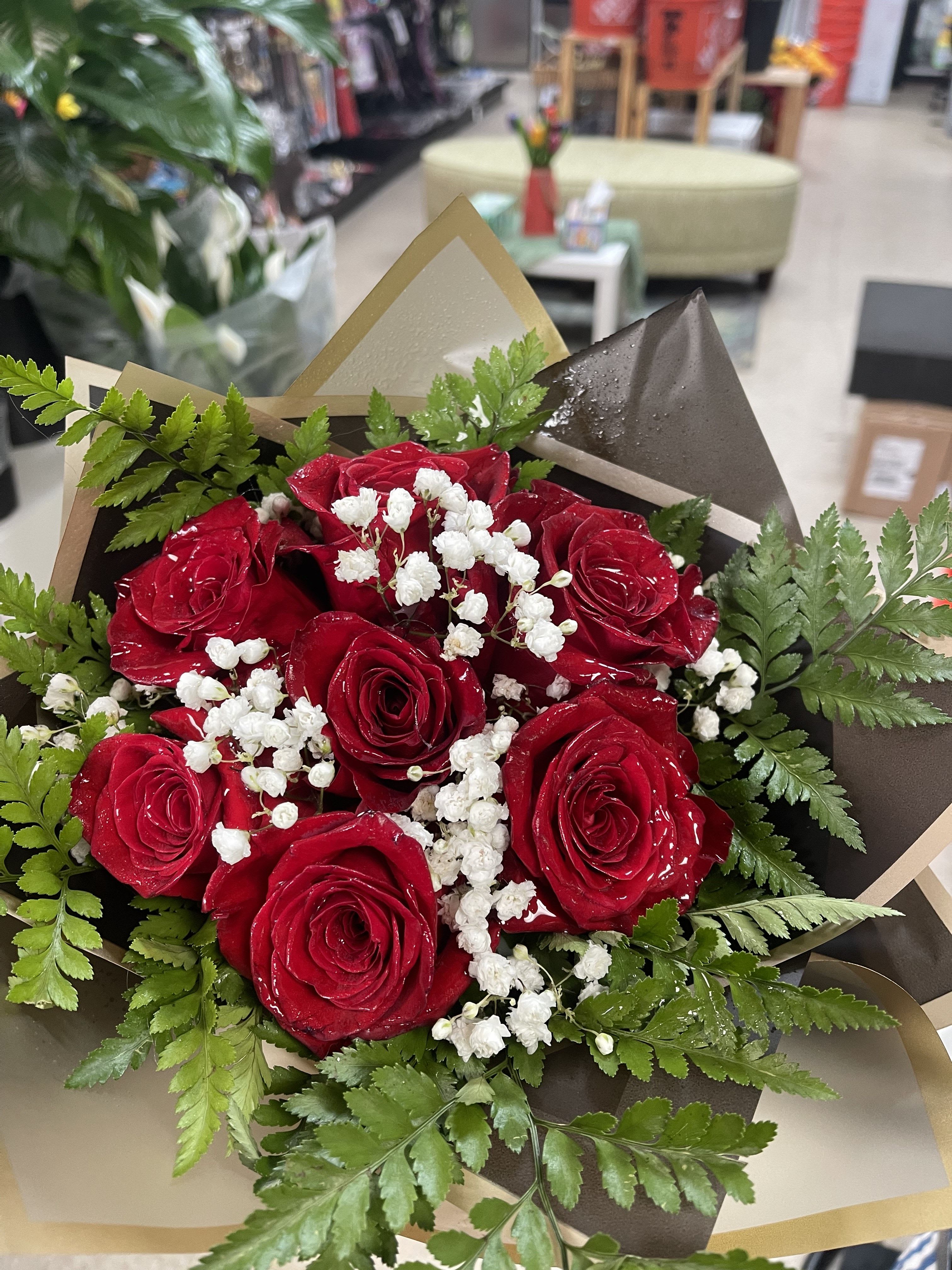 Bouquet of red roses with white baby's breath and greenery