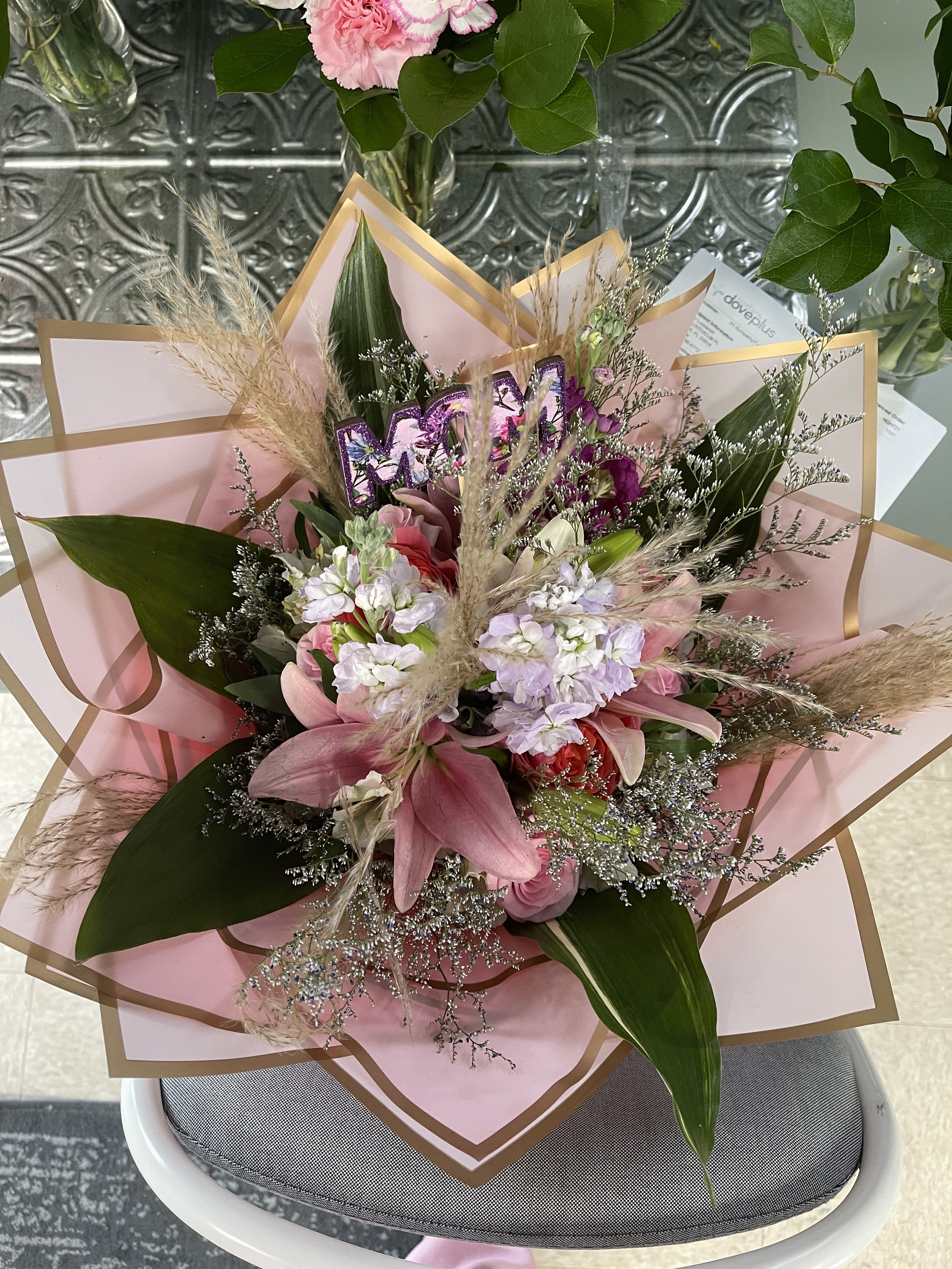 Pink and white mixed bouquet wrapped in blush paper