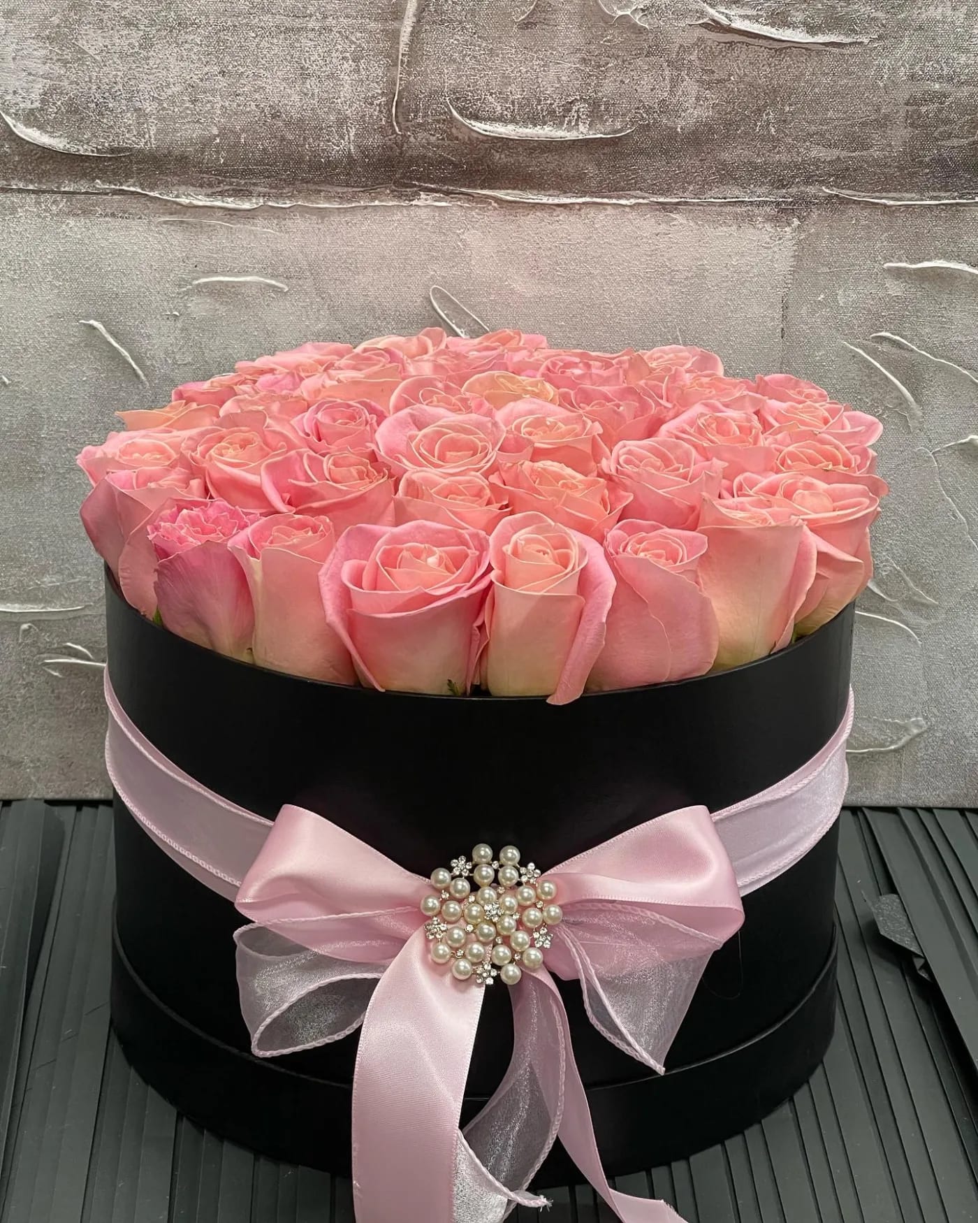 Pink Splendor Box  - 30 pink roses neatly incorporated into a black round box. Name of the Recipient will be included on the box. 40 roses on the deluxe and 50 on the premium size. 