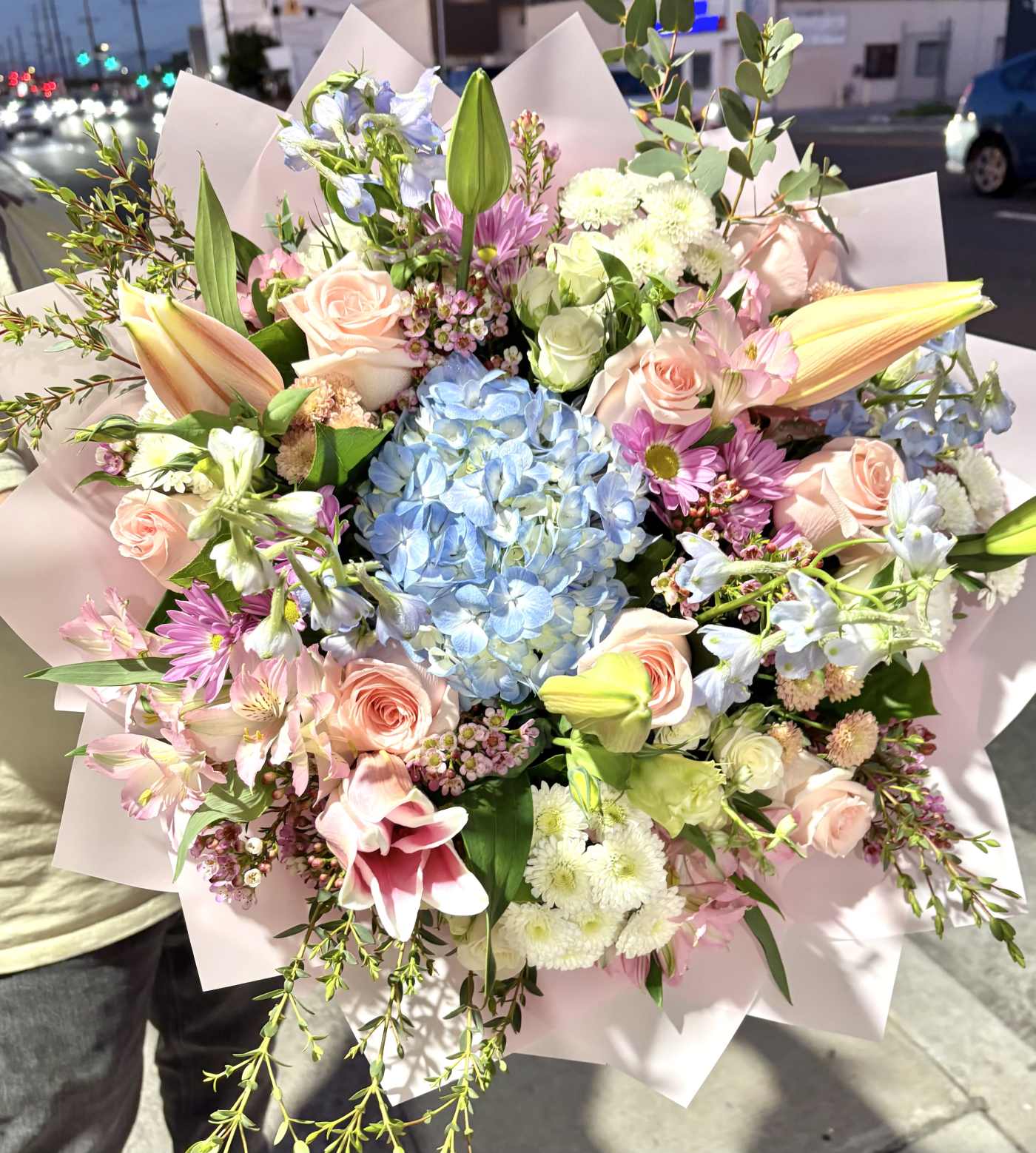 Large pastel bouquet with roses, lilies, hydrangea, and daisies