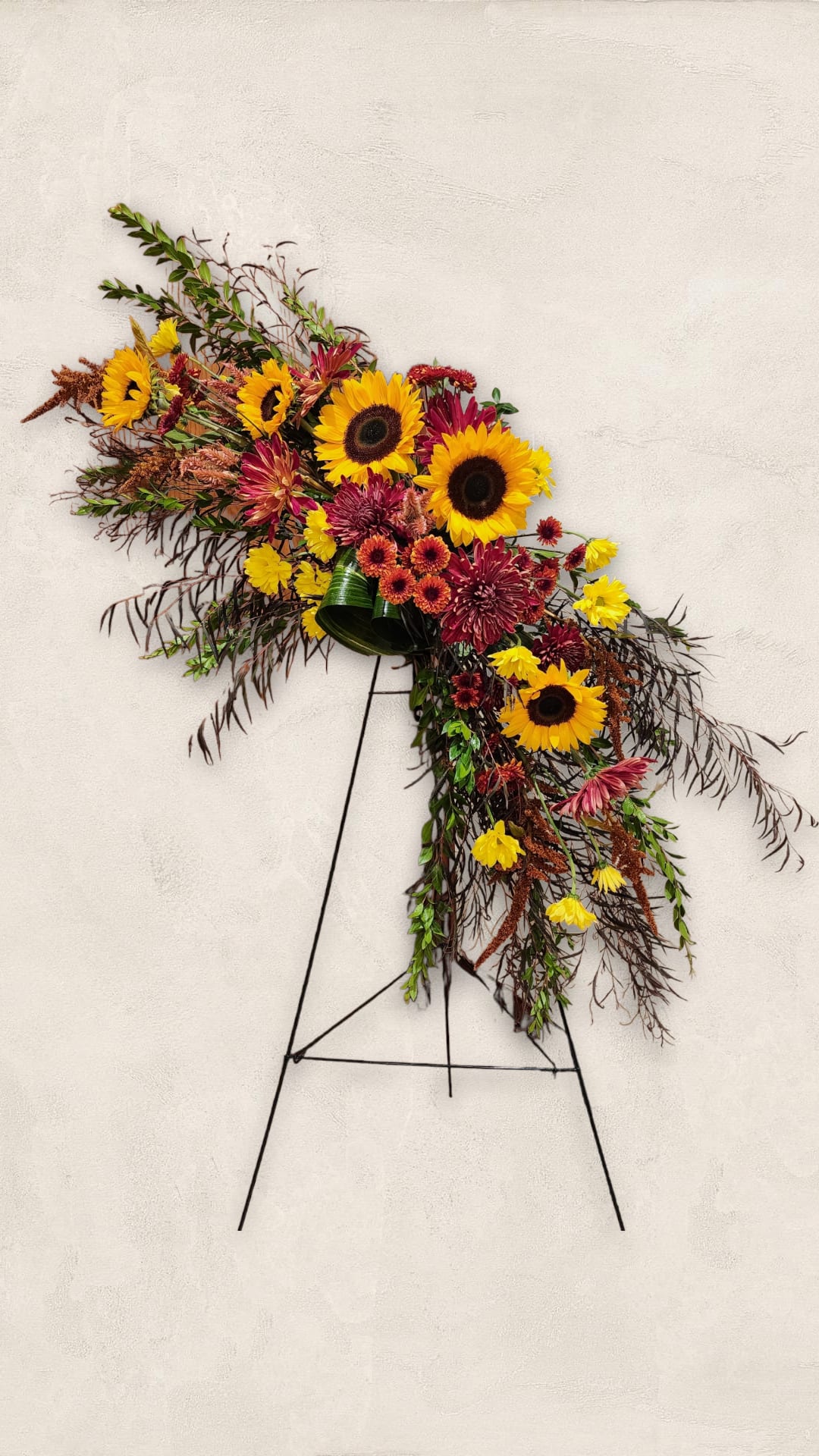 Large sunflower and chrysanthemum spray on a stand