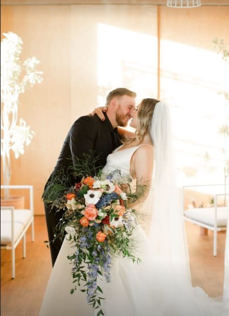 Bride and groom holding a cascading wedding bouquet