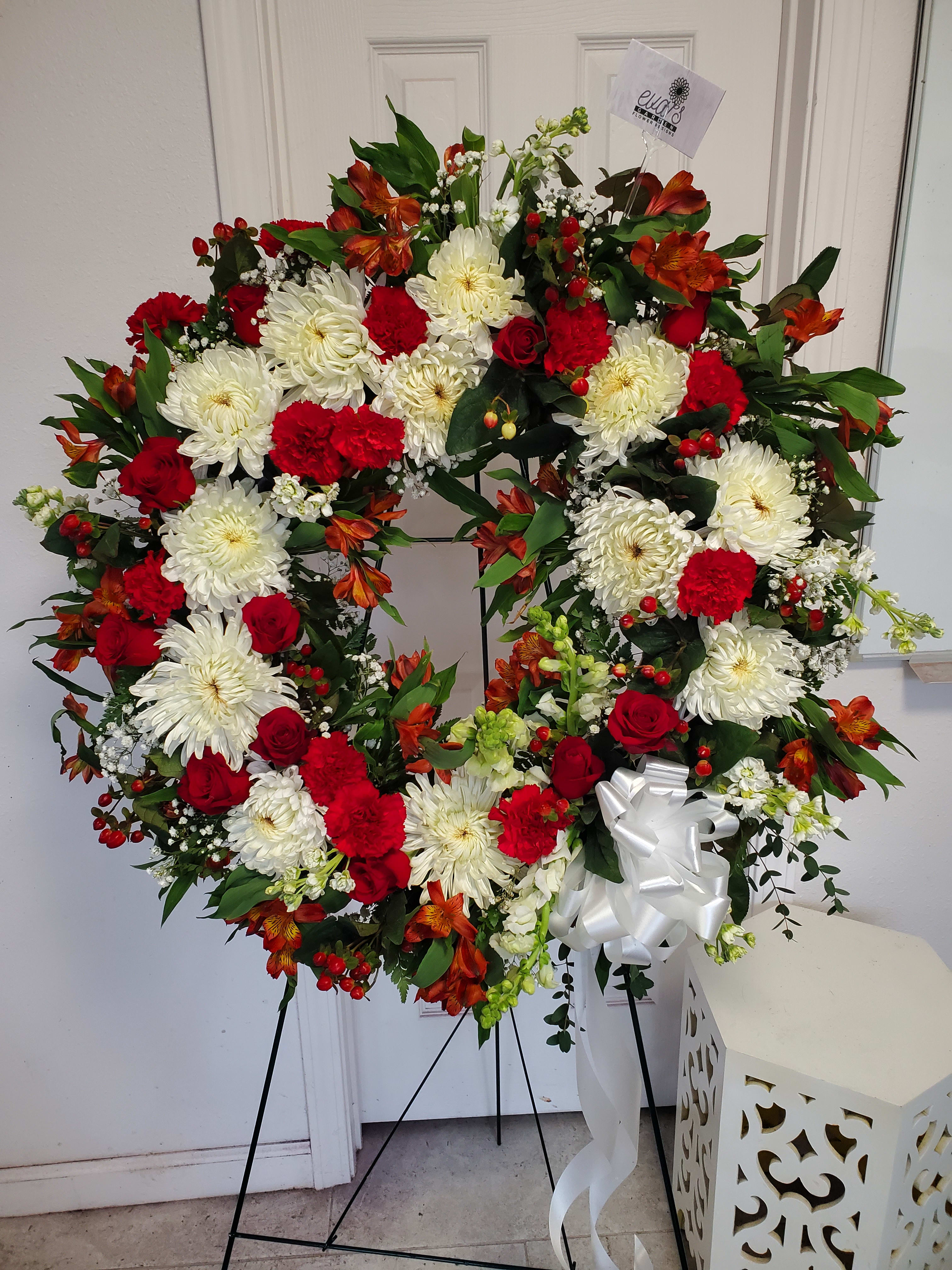 Red and White Circular Funeral Spray - Red and white circular funeral spray with chrysanthemums, roses, snapdragons, and other florals.   (Picture depicts a premium product; standard &amp; deluxe size available upon request)