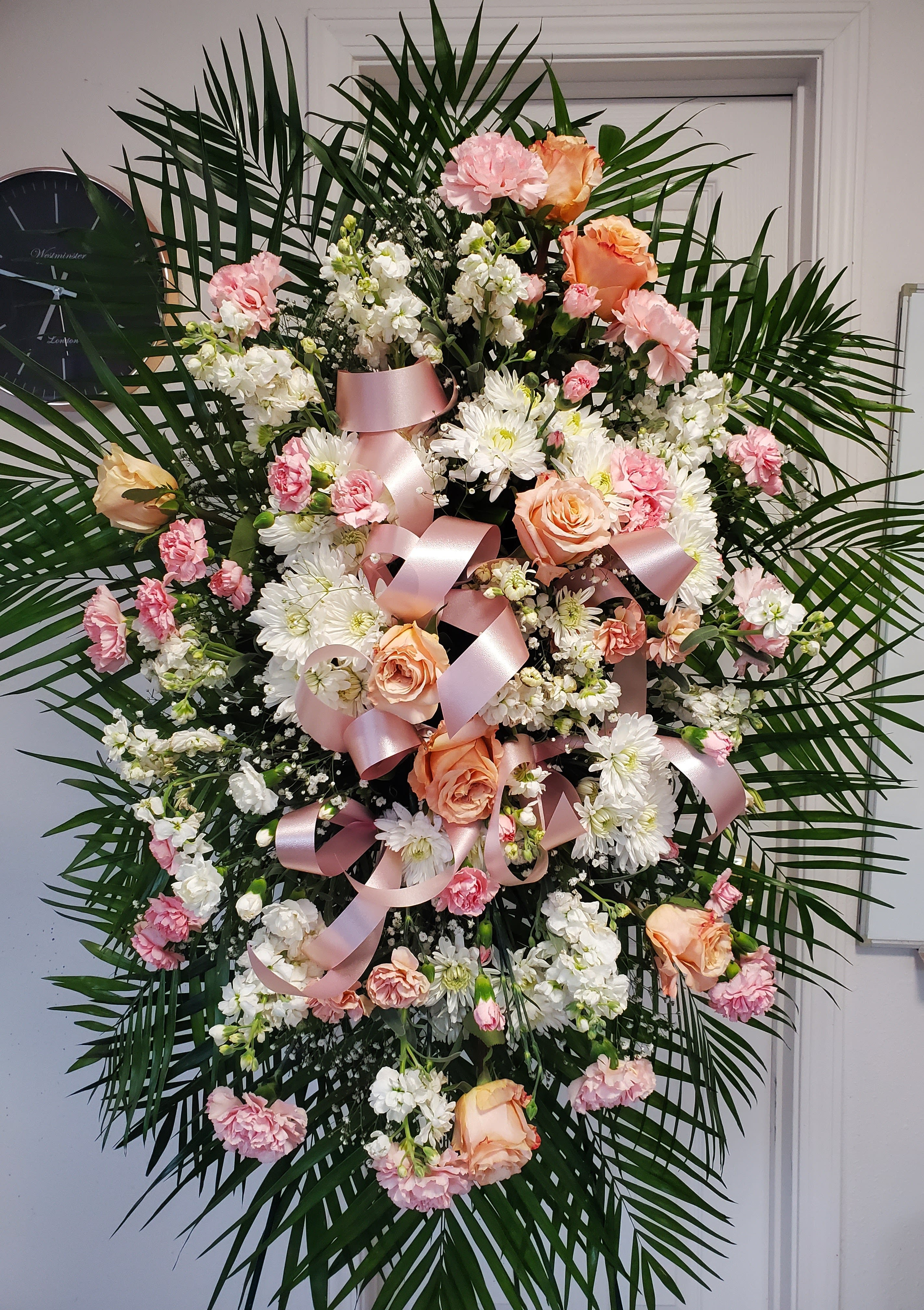 Peach &amp; White Funeral Spray - Peach and white funeral spray with mums, mini carnations, carnations, roses, stock, gypsophila.  (Picture depicts a deluxe product; standard &amp; premium size available upon request)