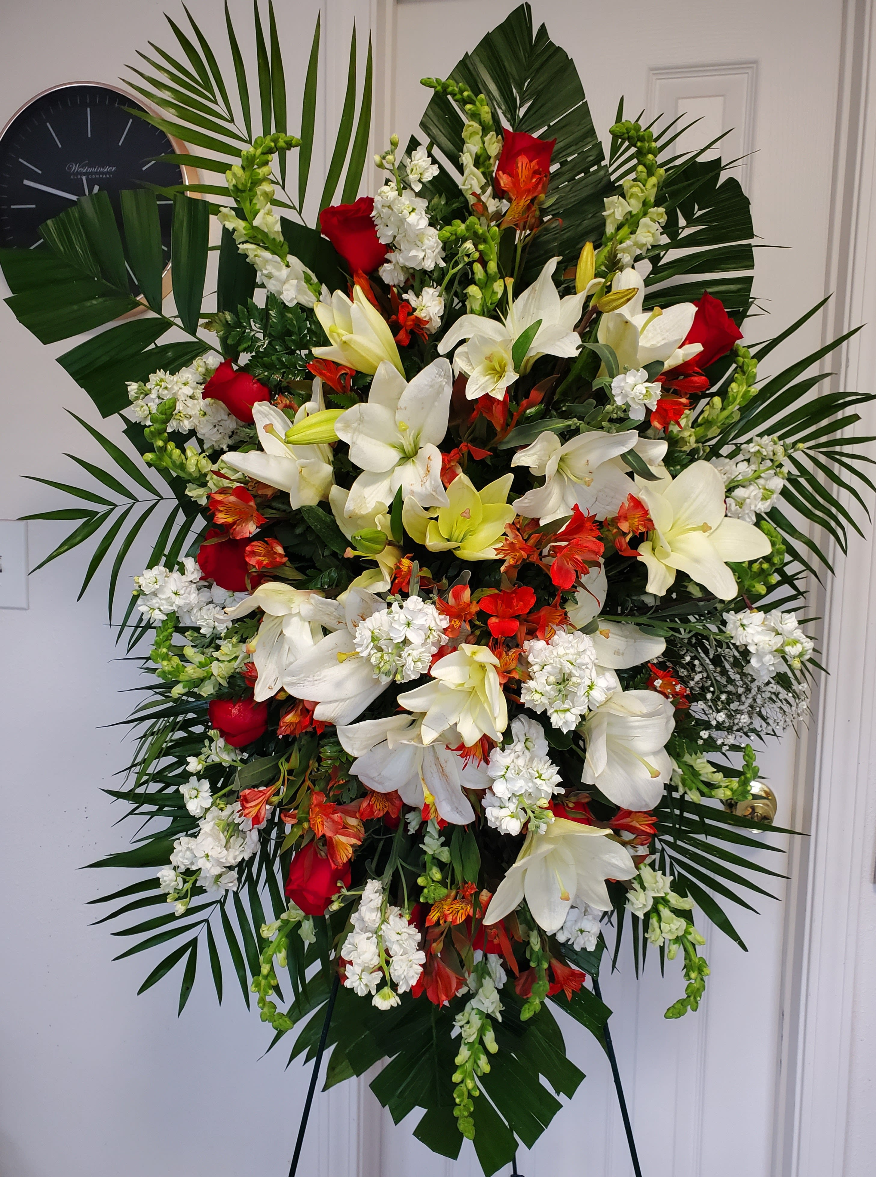 Red Roses &amp; White Oriental Lilies Funeral Spray - Red and white funeral spray with roses, oriental lilies, stock, snapdragons, alstroemerias,  and baby breath.  (Picture depicts a deluxe product; standard &amp; premium size available upon request)