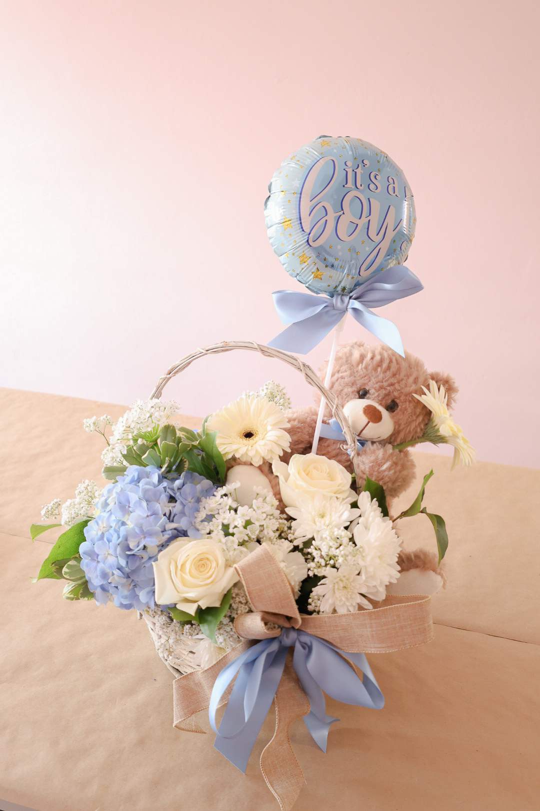 Flower basket with a teddy bear and a "it's a boy" balloon