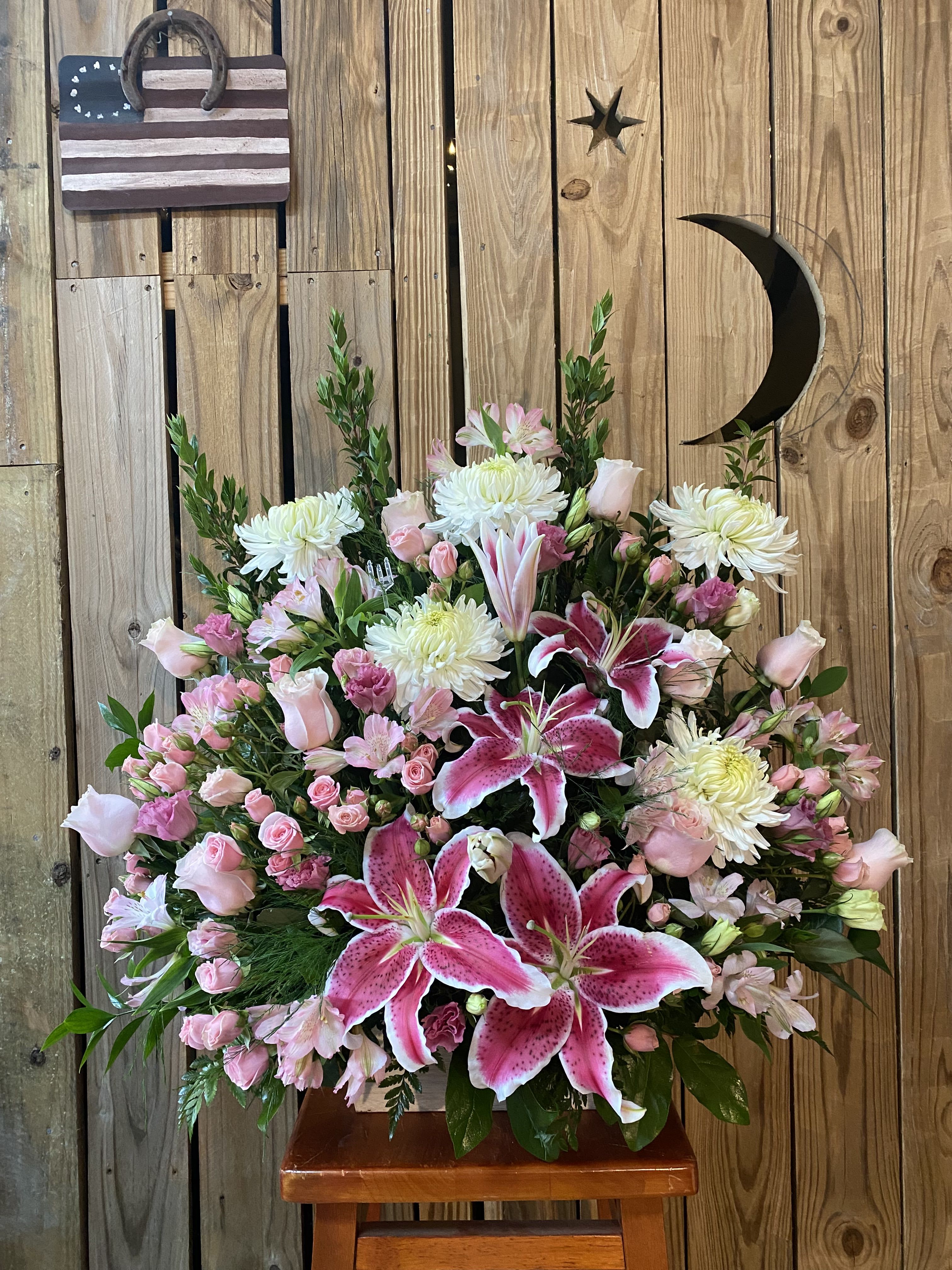 Large pink and white floral arrangement with lilies and roses