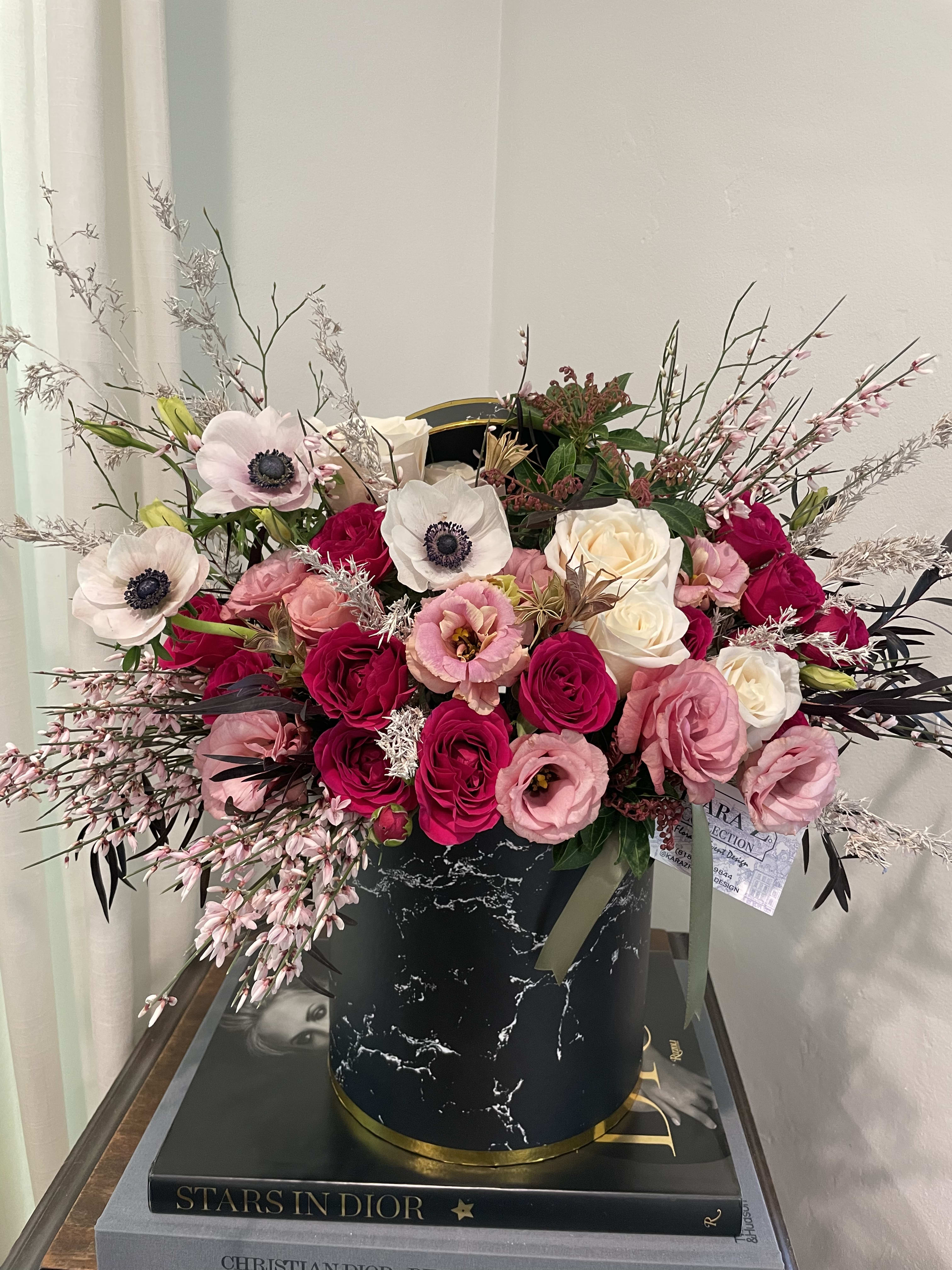 French Fuchsia  - Eye catching fuchsia roses, soft pink lisianthus, and lush greens arranged in a hat box style with other premium and seasonal florals to create a one of a kind arrangement. Ideal for any occasion and sure to make a statement. 