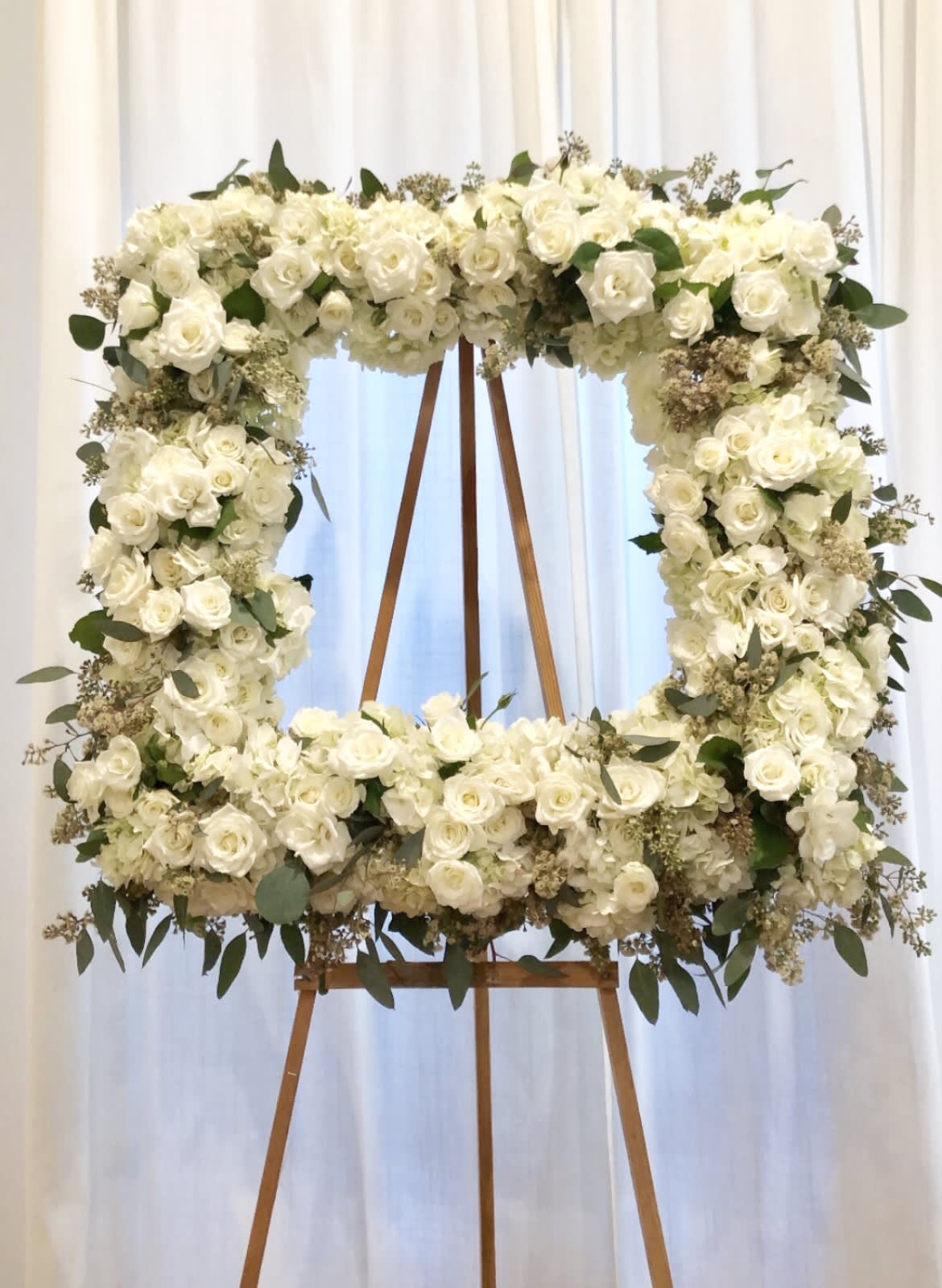 Graceful Life - Graceful life design in a mixture of lush roses, hydrangea, and lush greens. The perfect selection to celebrate your loved one.   Our designs are sure to stand out as each arrangement is carefully created to capture the emotion with flowers. Arrangement comes with aisle and ribbon with your choice of writing. 