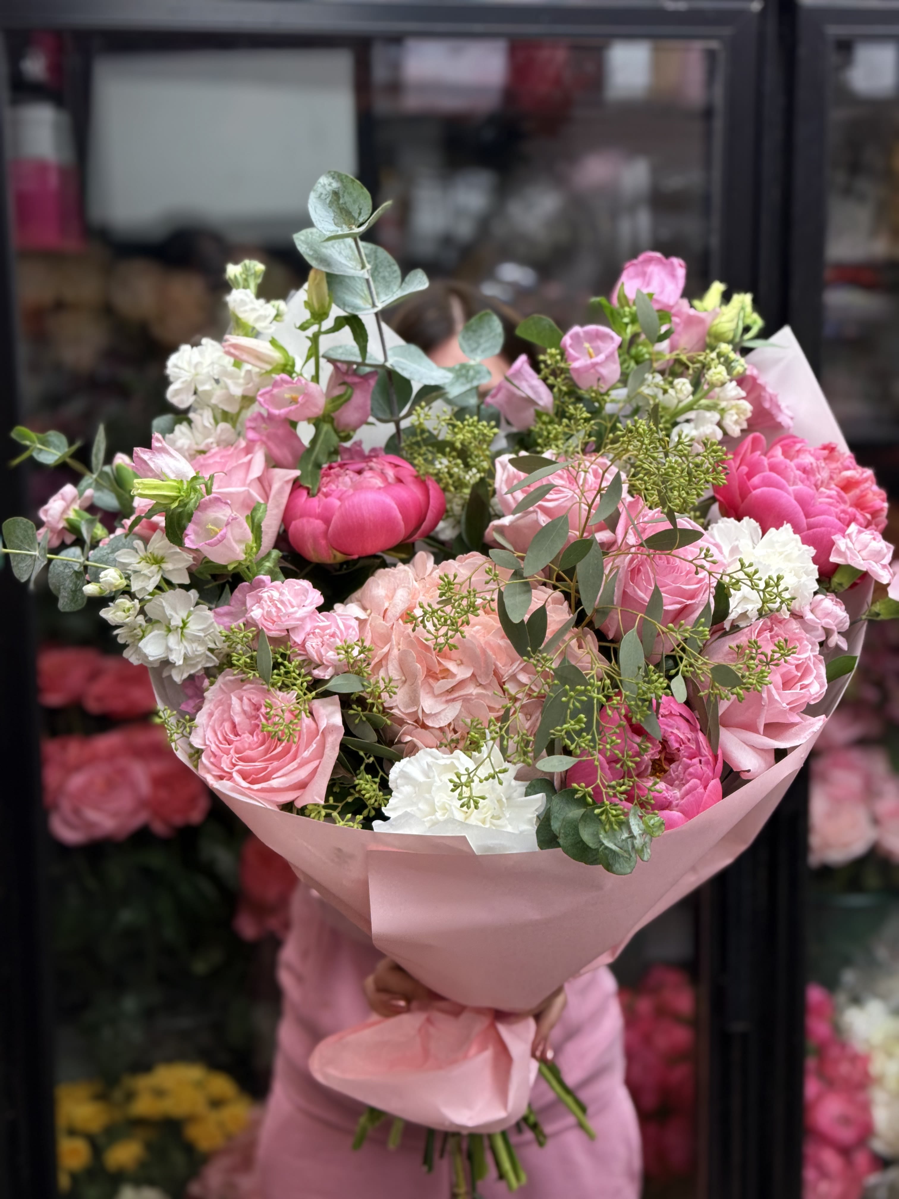 Pink and white mixed bouquet wrapped in pink paper
