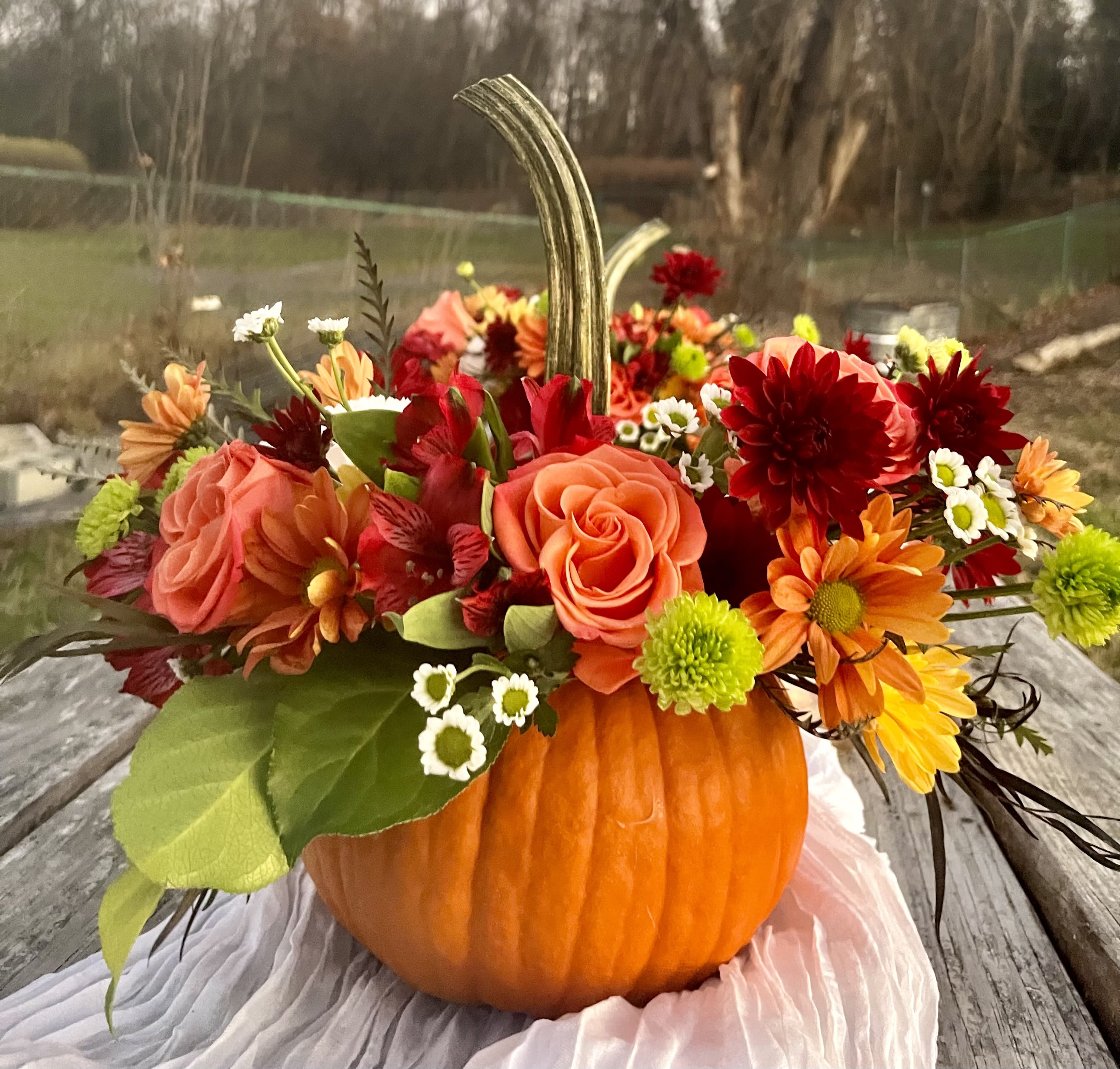 Grateful  - Combine your Flower Power with Pumpkin Power with this wonderful, dare we say “powerful,” seasonal arrangement. Housed in a fresh pumpkin vase, you will surely “fall” in love with this collection of fall flowers this fall.