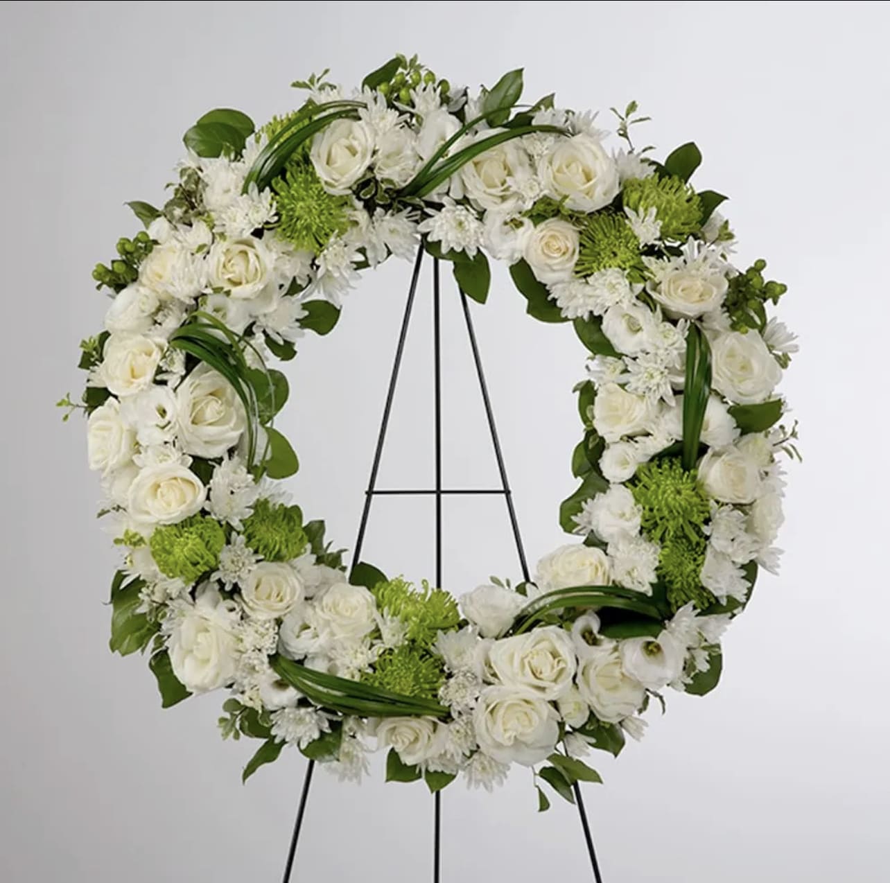 Lasting Serenity  - A beautiful white and green tribute wreath that calms, this easel arrangement celebrates a full life and a peaceful passing. 