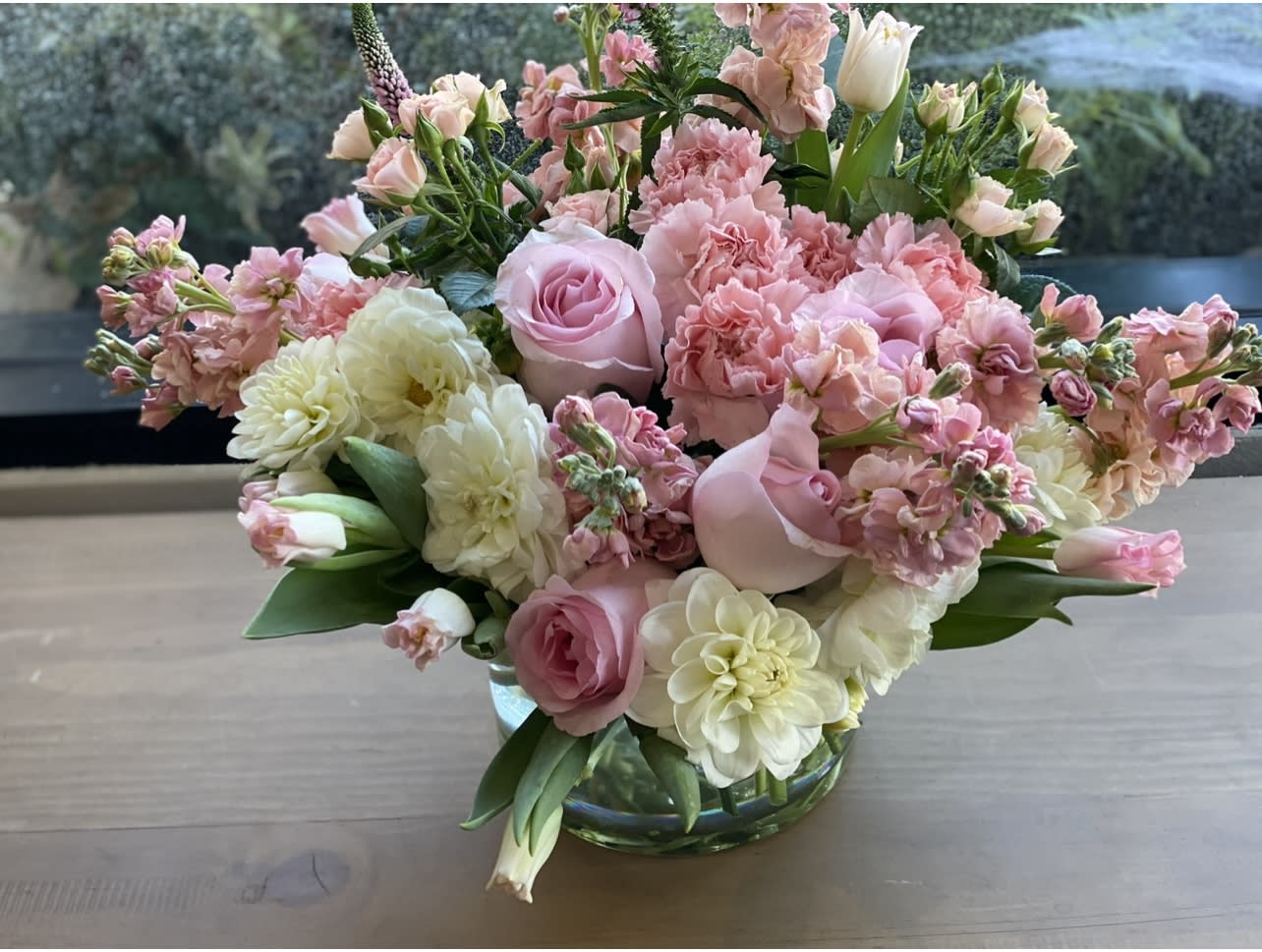 Pink and white floral arrangement in a glass vase