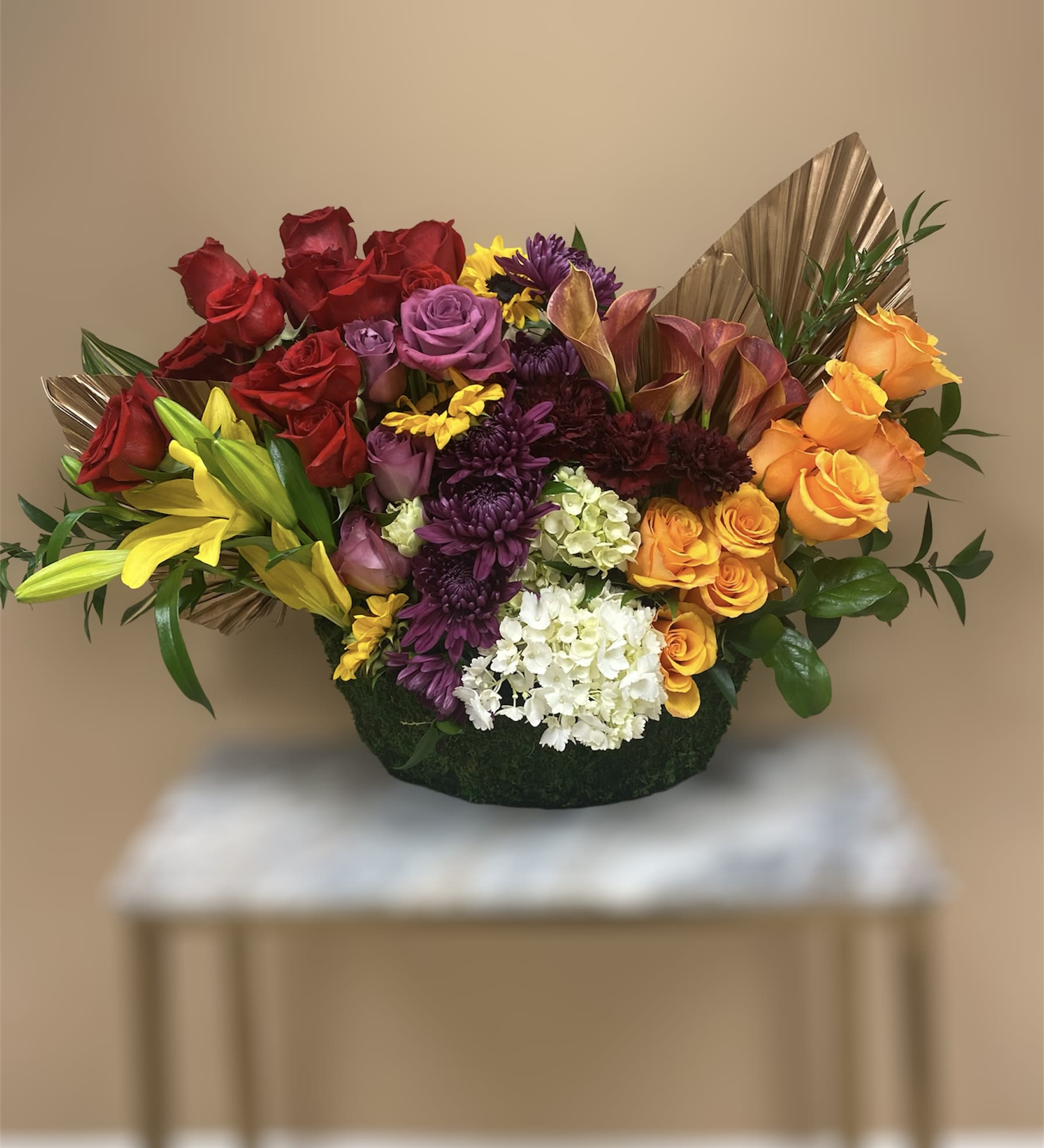 Big Canoe - A medley of lilies, roses, hydrengeas  and mums arranged in a very neat modern format. What an impression this arrangement will make for any occasion or something exciting to place at a Welcome table. Call us today for details!
