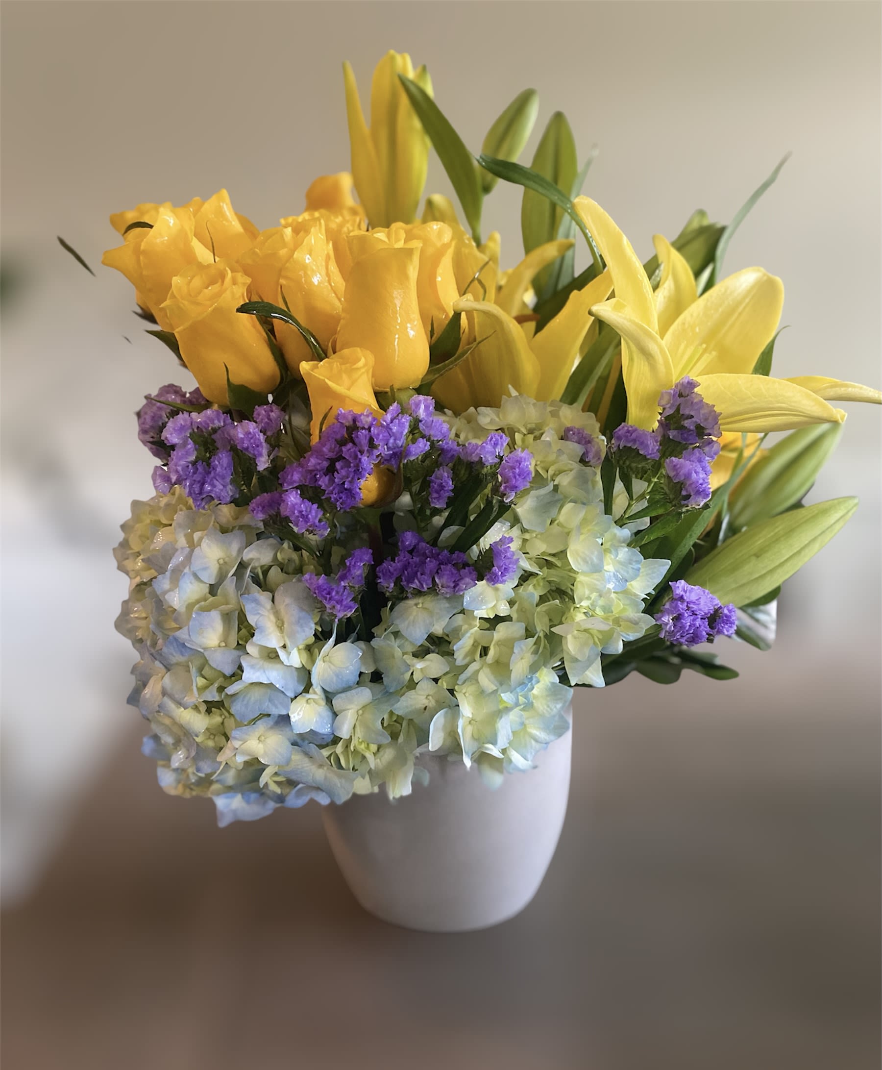 Laurel Canyon - Know someone sad? Know someone who’s had a rough week? Perhaps they may be in need of some Joy…The Flist Joy is a very modern arrangement with clusters of yellow roses, purple statice, Lillies and a blue hydrangea. Once you’ve experienced Flist Joy, you can’t help but feel better.