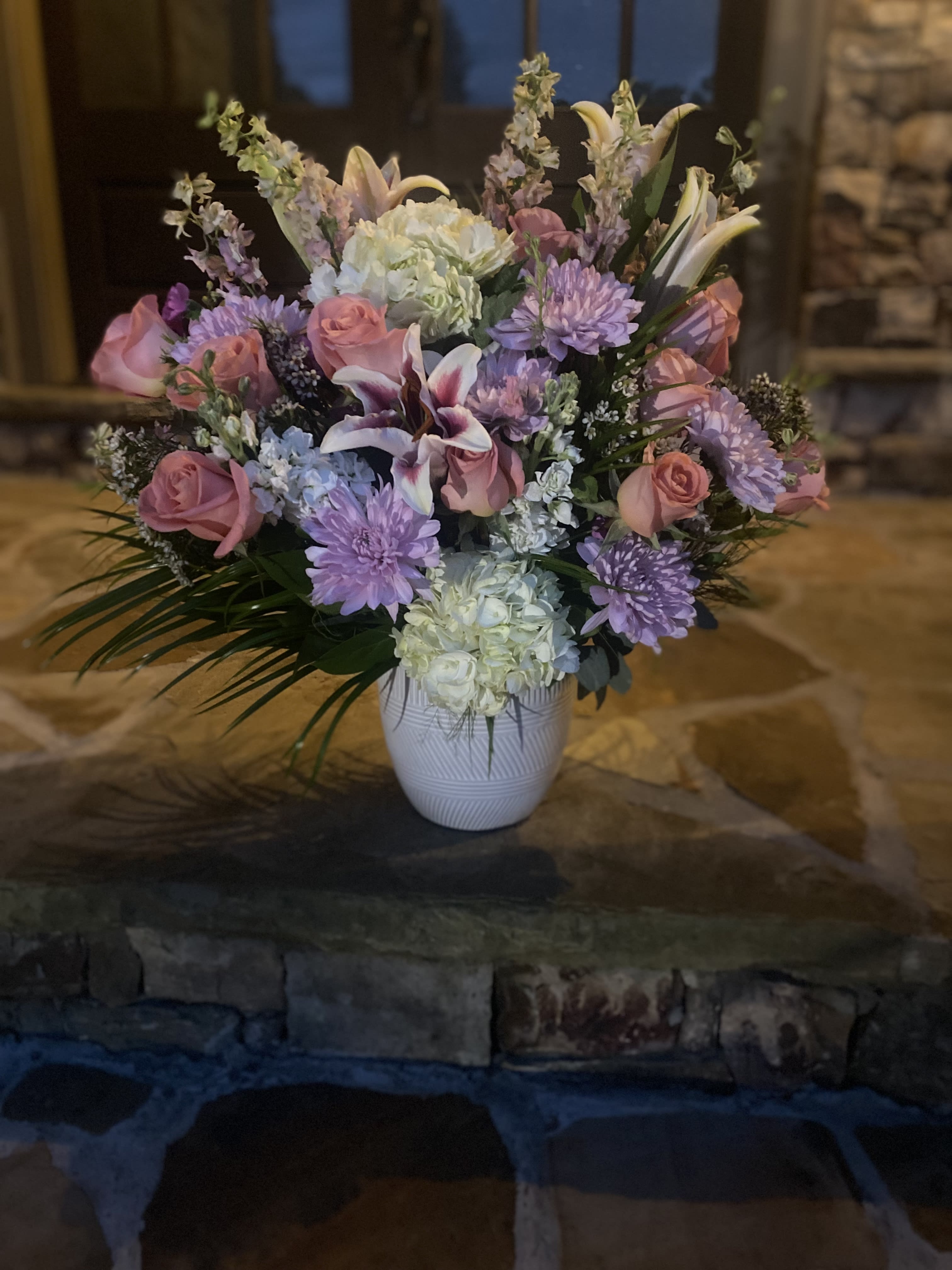 La Lovie - La Lovie has a medley of white, pinks &amp; peach tones with a touch of lavender (specific florals listed below)*. Whether a it’s sent to congratulate a loved one for a huge accomplish or if it’s sent just to say I’m sorry, you’re sure to be greeted with the biggest smile of approval!   *Subject to substitution if recipe is not available. We will guarantee the same look &amp; quality.  -jade leaves -Robellini  -pink or coral roses -lavender Mums -white stock -seasonal greenery fillers -pink or white delphinium  -ivory hydrengeas -Stargazer lillies