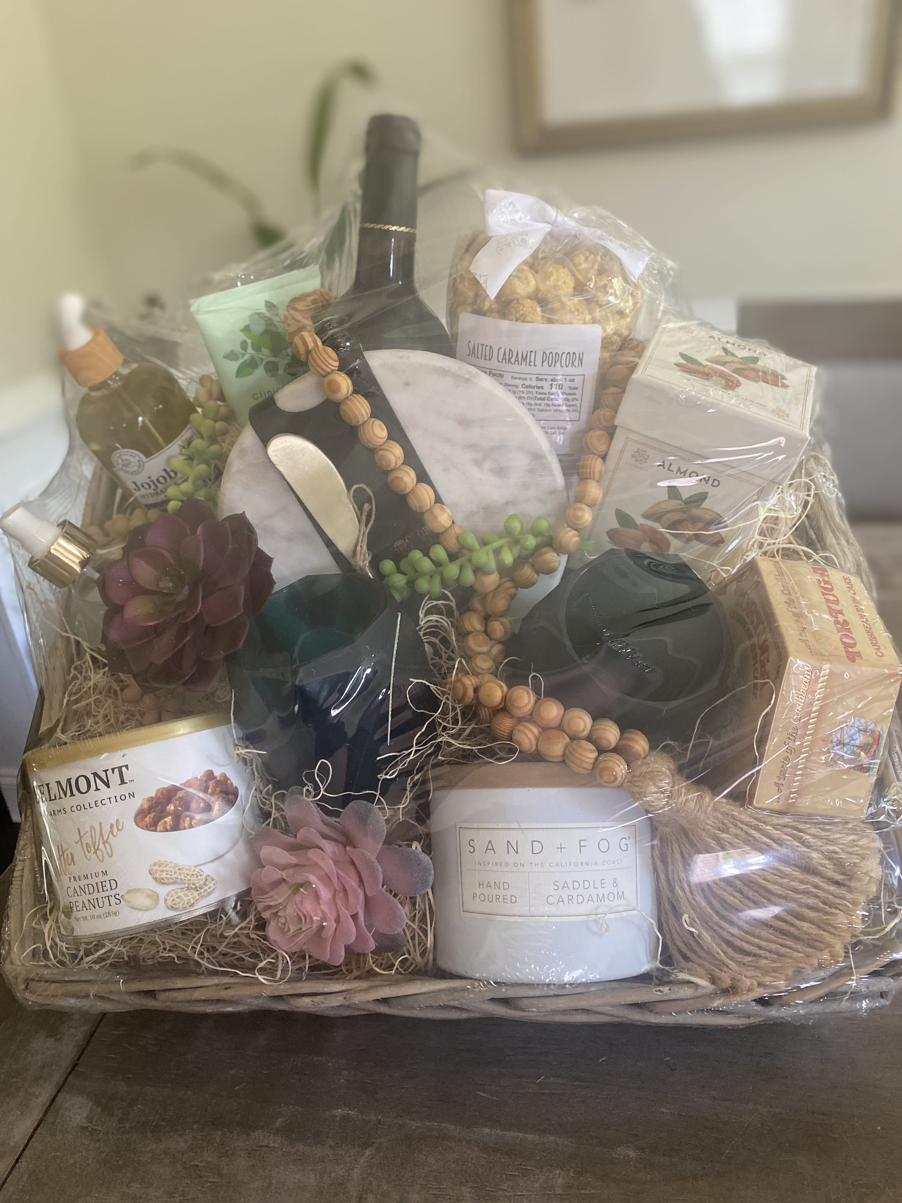 BridgeMill Basket - Perfect for that special couple or for the friend who needs a little self care retreat. Send a note of thoughtfulness with a carefully curated basket full of goodness!    What’s Inside Premium Basket (Shown): -All over body oil  -Linen spray -Luxurious candle  -Gourmet Caramel Popcorn -Mini Rum cake -Miniature charcuterie board -Candied peanuts (or chocolates if local) -Lux soap -Lux foot scrub -Bottle of red wine -Set of matching goblets  -Set of home decor beads  What’s Inside Deluxe Basket: -Miniature charcuterie board -Candied peanuts (or chocolates if local) -Lux foot scrub -Bottle of red wine -Set of matching goblets   What’s Inside Standard Basket: -All over body oil  -Luxurious candle  -Bottle of red wine -Set of matching goblets        