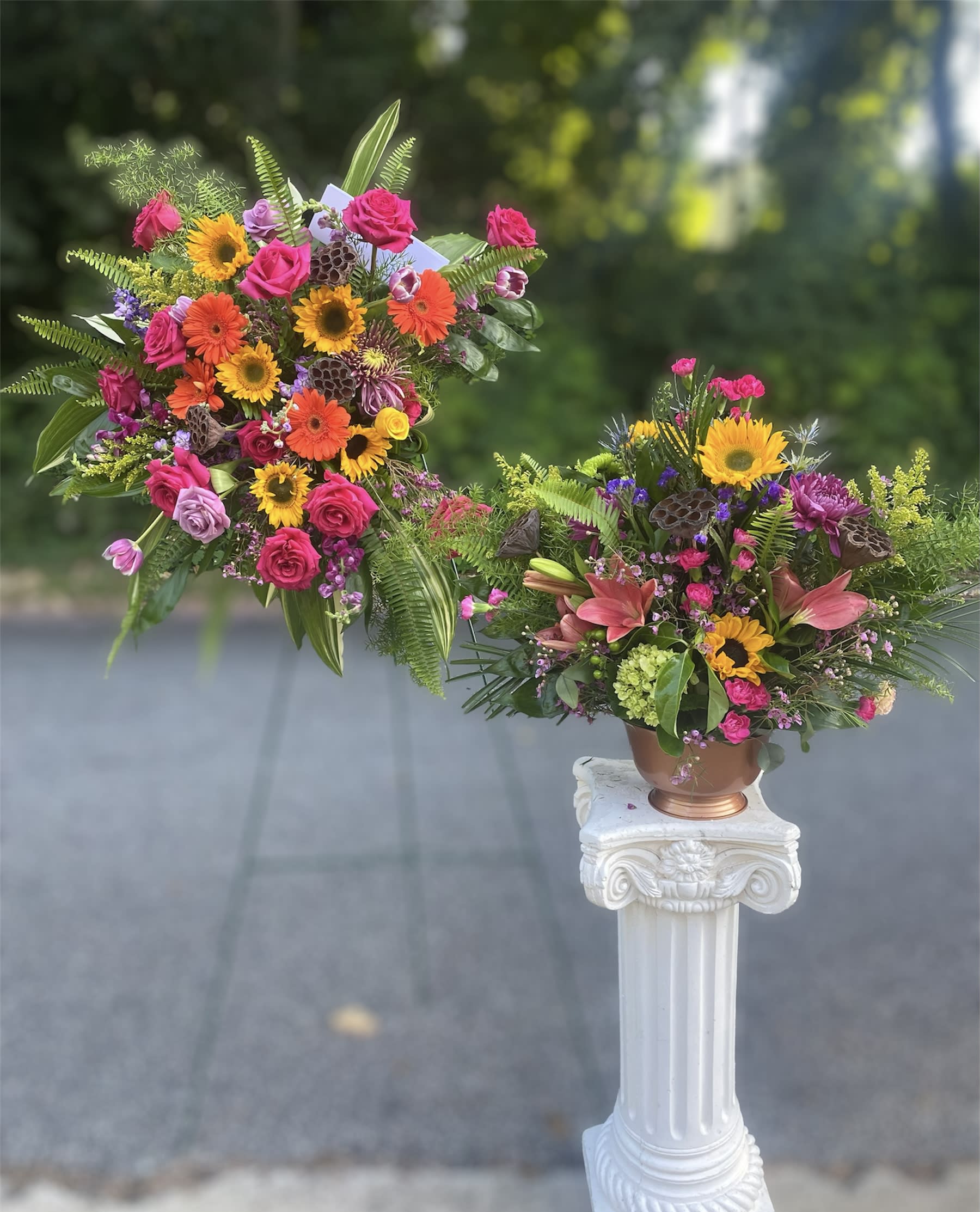 Sunshine Celebration - Celebrate a loved ones life with the beautiful Sunshine Celebration which will include a standing spray and a sizable 20 inch high platform arrangement.   