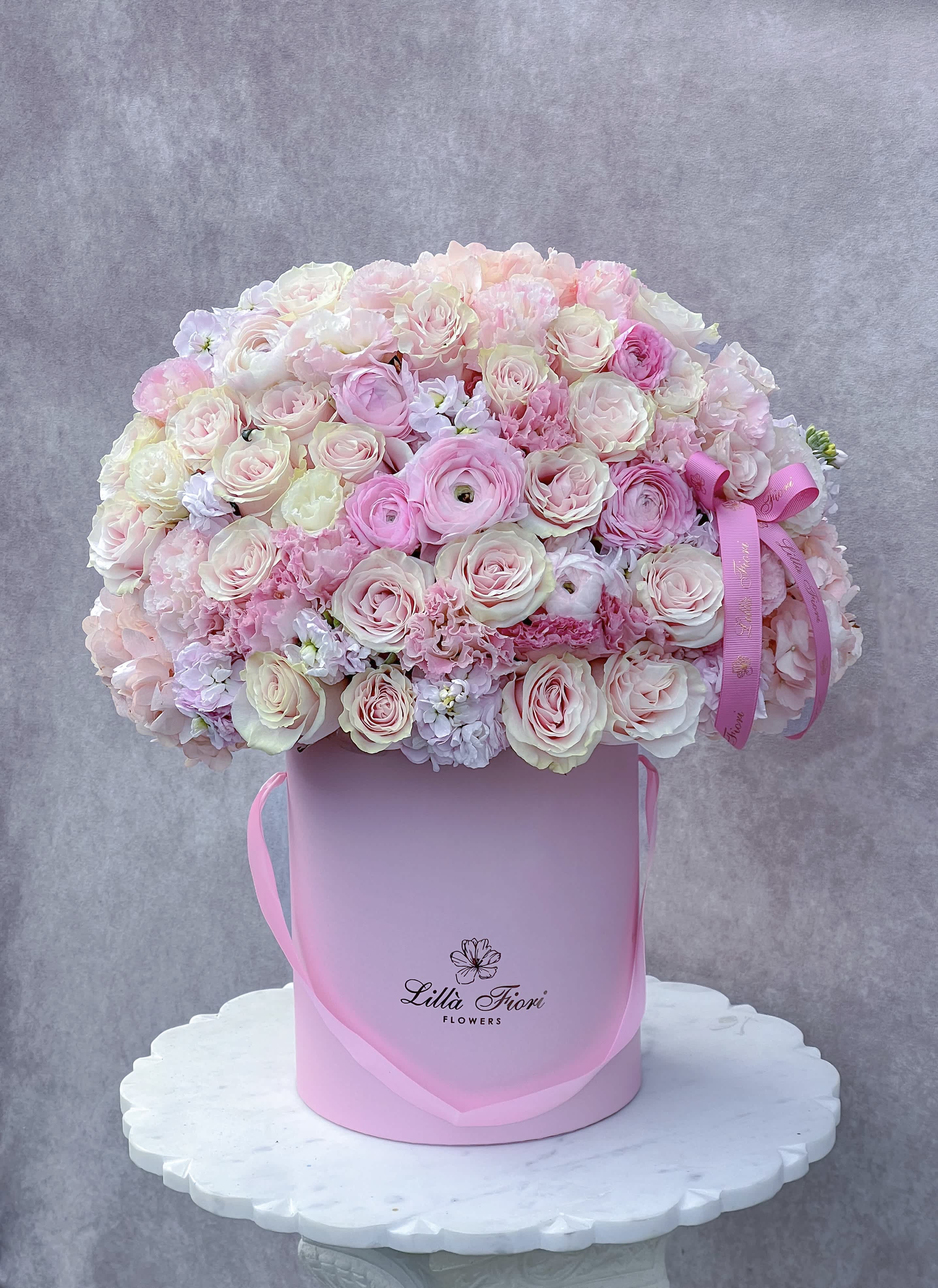 Large pink and white rose bouquet in a pink hat box