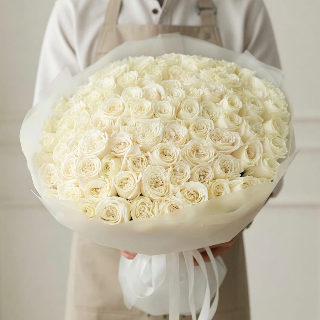 Large bouquet of cream roses wrapped in white paper