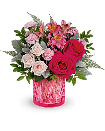 Teleflora's Vintage Elegance Bouquet - Take their Valentine's Day breath away with this stylish pink rose bouquet, presented in an artisanal mosaic vase of stained glass that swirls in stunning shades of pink. Hot pink roses, light pink spray roses, miniature pink carnations and dark pink alstroemeria are arranged with pink sinuata statice, leatherleaf fern, huckleberry and dusty miller. Delivered in Teleflora's Vintage Elegance cylinder.