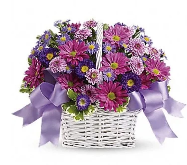Basket of purple and pink daisies with a lavender ribbon