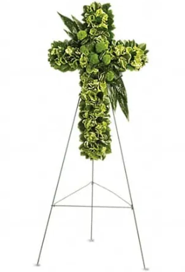 Green floral cross arrangement on a metal easel