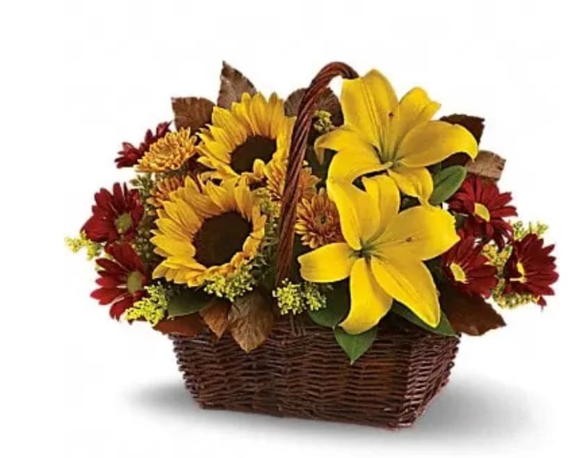 Basket arrangement with sunflowers, yellow lilies, and red daisies