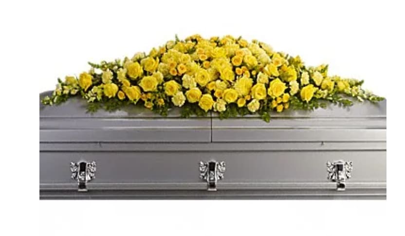Yellow flower spray on a gray casket