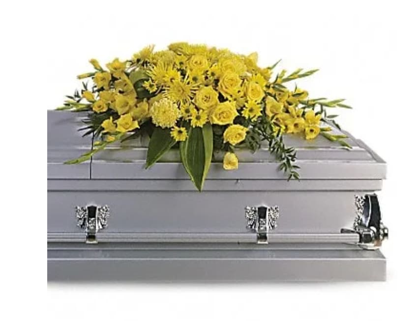 Yellow floral spray on a silver casket