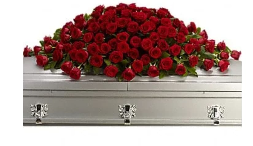 Red rose casket spray on a silver casket
