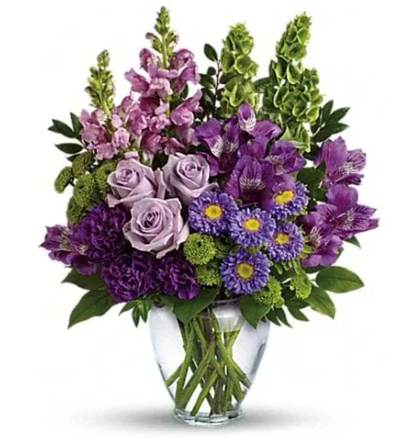 Purple and lavender bouquet in a clear glass vase