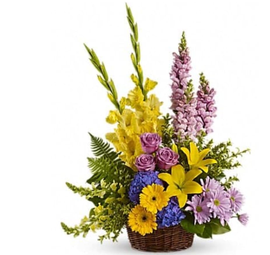 Colorful mixed flower arrangement in a wicker basket