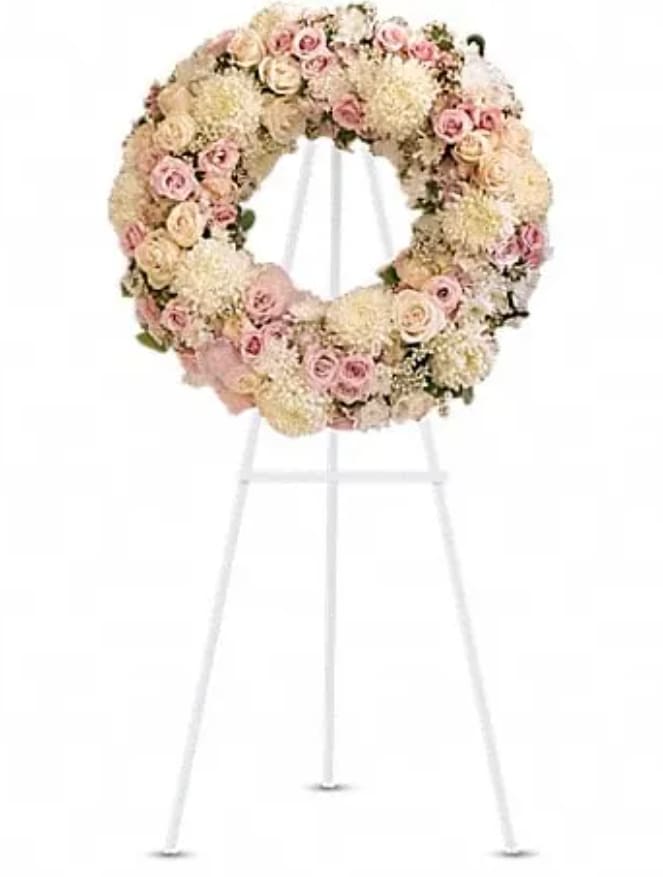 Pastel floral wreath on a white stand