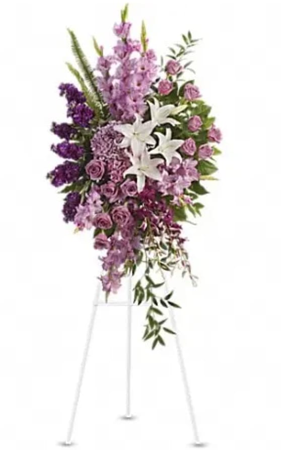 Tall purple and white floral spray on a stand