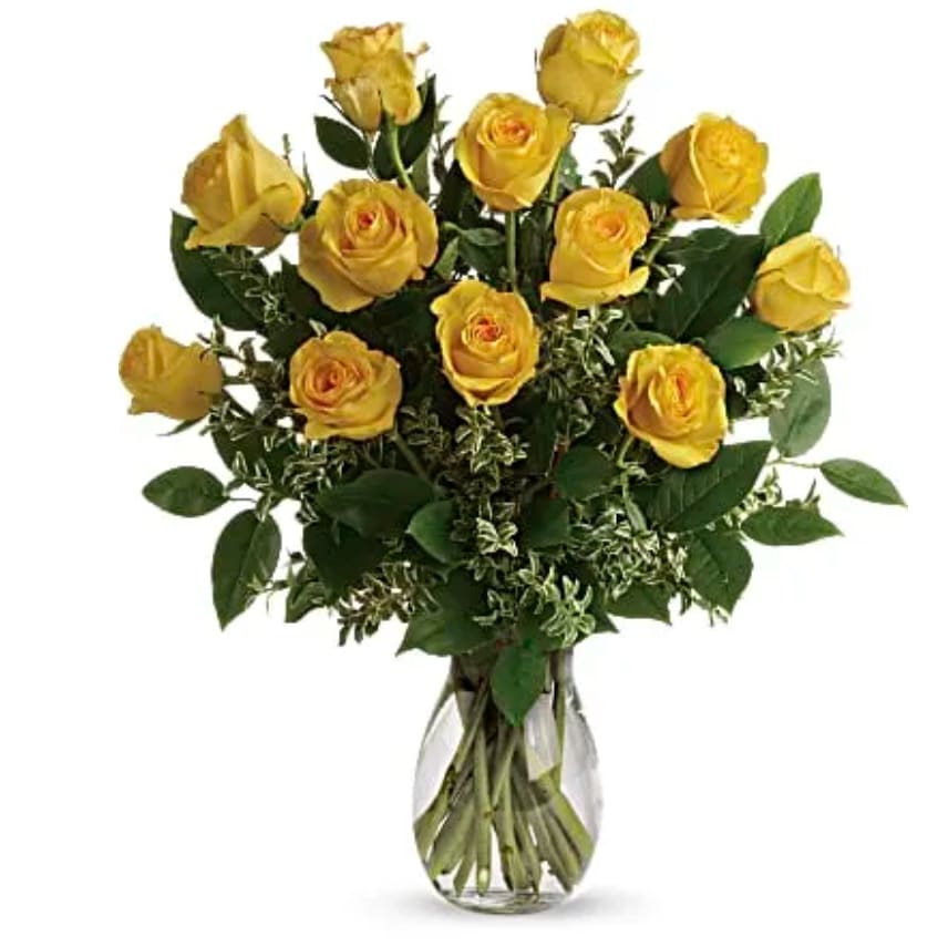 Yellow roses arranged in a clear glass vase