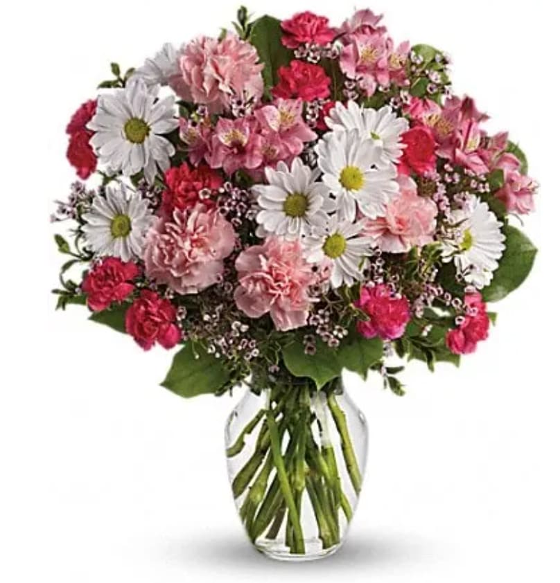 Pink and white mixed flowers in a clear glass vase