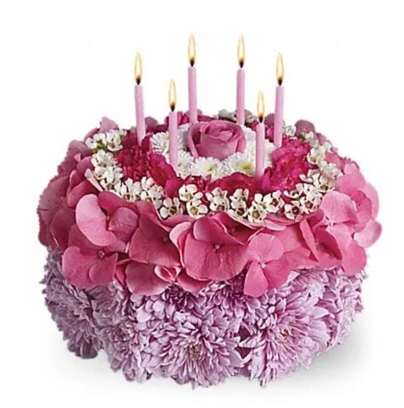 Pink floral cake with five lit candles