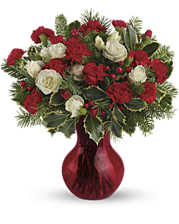 Teleflora's Gather Round Bouquet - Fill your winter with joy. This sweet arrangement features white spray roses and red miniature carnations presented in our sweet red Serendipity vase. White spray roses and red miniature carnations are accented with tips of douglas fir, holly and red berry spray. Delivered in Teleflora's red Serendipity vase. Orientation: All-Around  SUBSTITUTION POLICY – Always deliver the freshest flowers! Please note the bouquet pictured reflects our original design.  If the exact flowers or container in this arrangement are not available, our local florists will create a beautiful bouquet with the freshest available flowers.