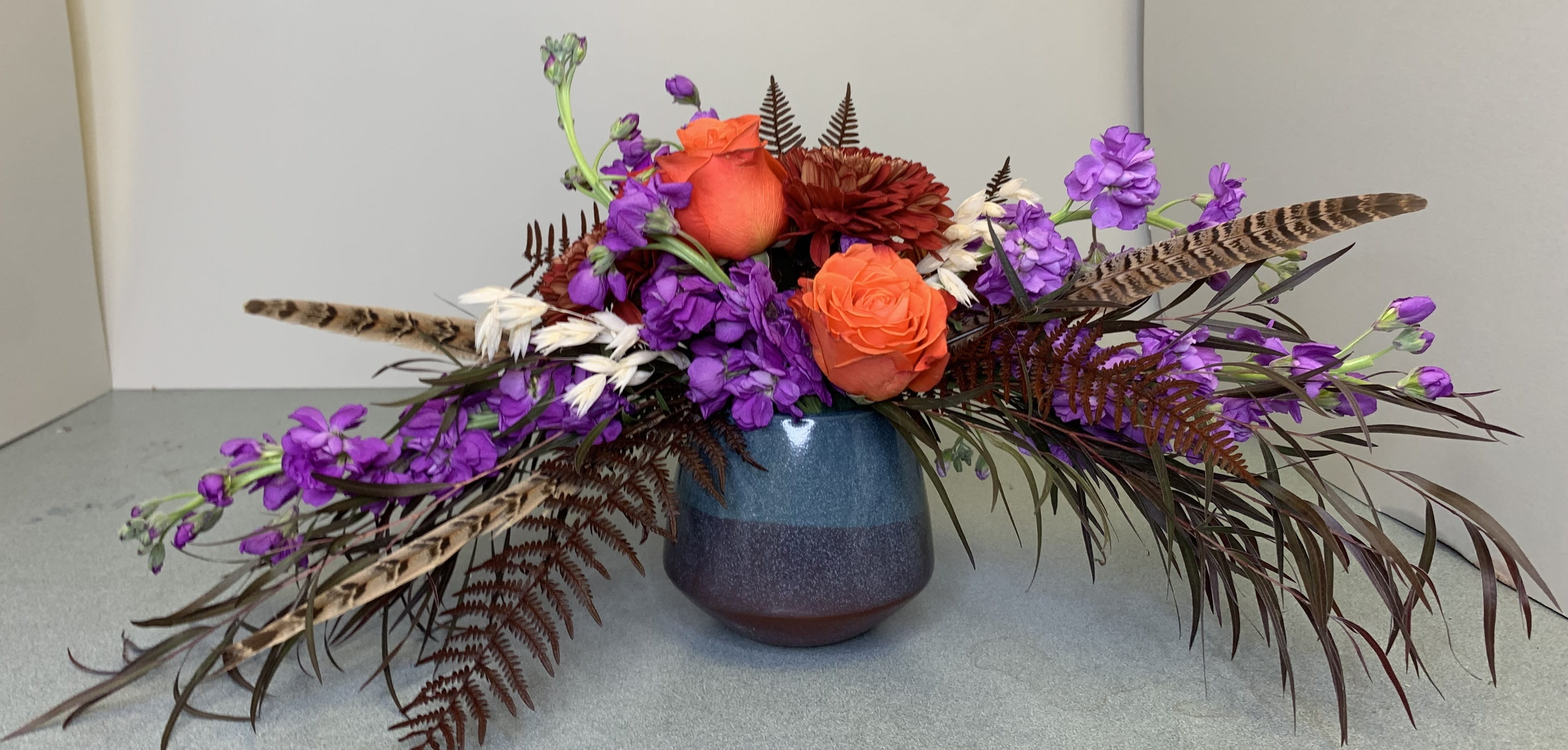 Deep Fall - The extraordinary, rich colors of this modern design welcome any fall occasion. The deep fall would make a fabulous hostest gift for a holiday gathering or show of affection for every day. Pheasant feathers provide eye catching accents along with dried and preserved details make this a design that won't be forgotten.